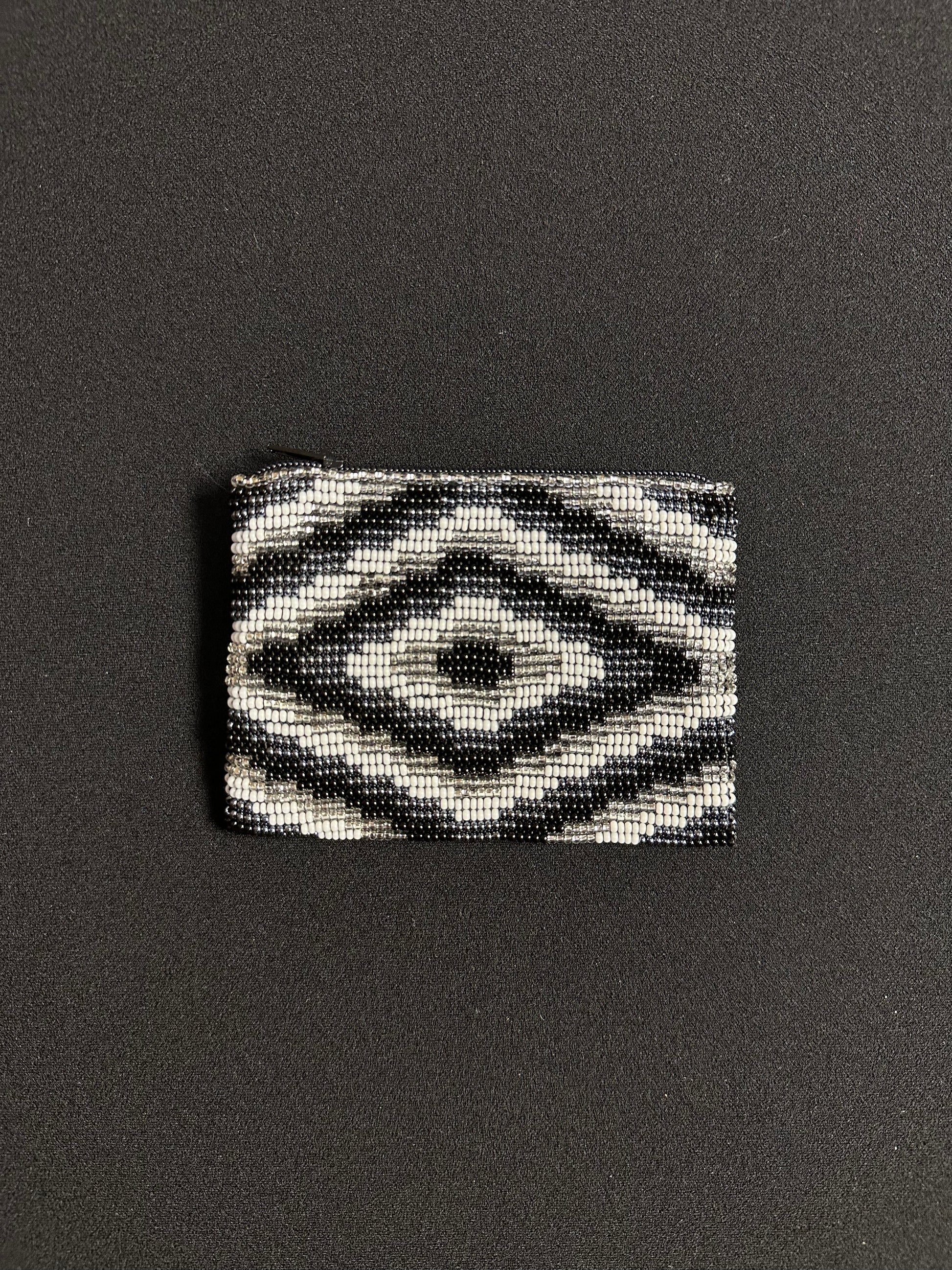 These Guatemalan Hand Beaded Coin Purses are a handcrafted piece of art. Handmade with beads, each purse is lined with a silky nylon lining and closes with a zip-top closure. They are great for organizing items in your purse or bag, and hold credit cards, IDs, metro passes, and change. Perfect for everyday use.