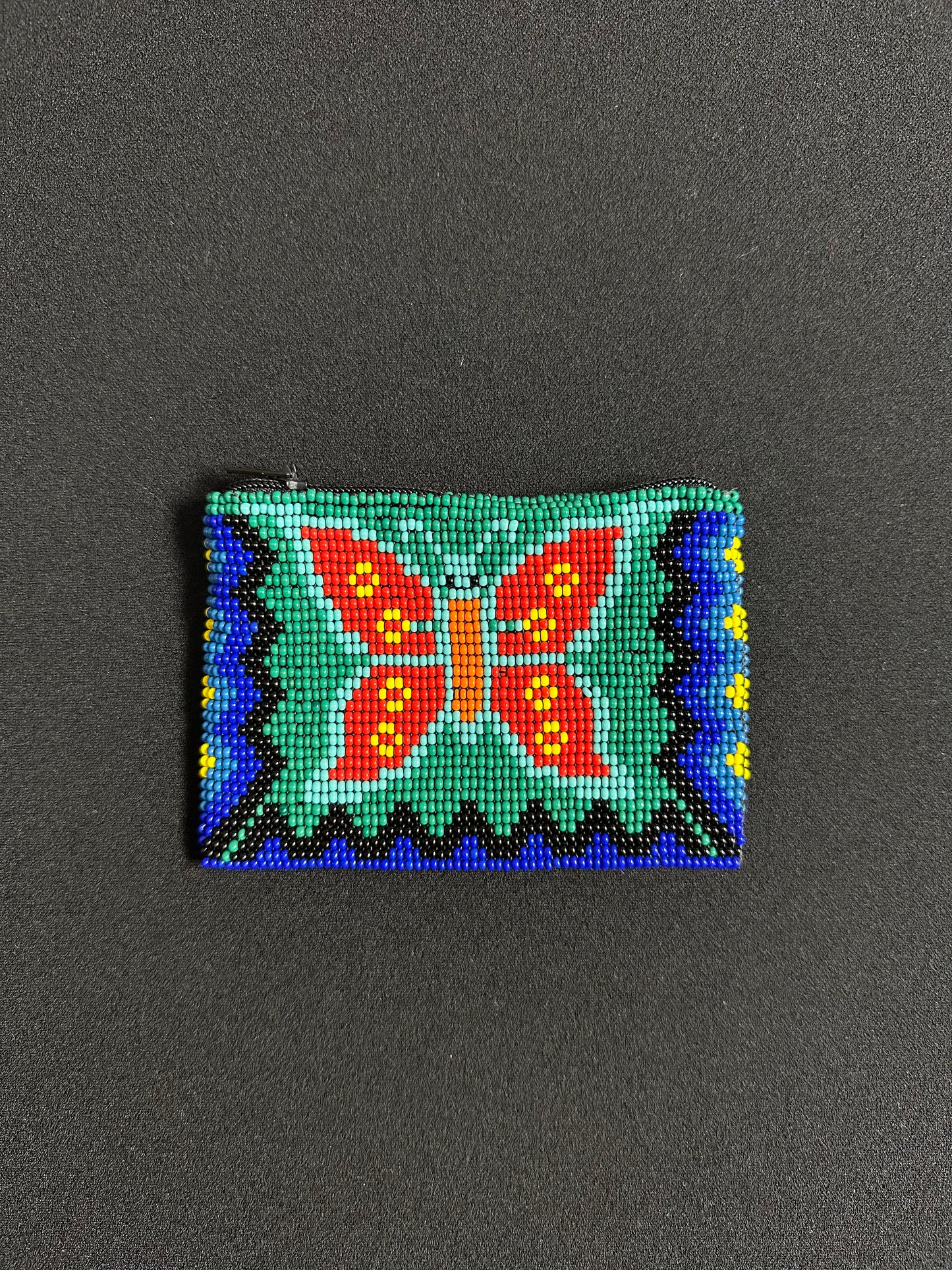 These Guatemalan Hand Beaded Coin Purses are a handcrafted piece of art. Handmade with beads, each purse is lined with a silky nylon lining and closes with a zip-top closure. They are great for organizing items in your purse or bag, and hold credit cards, IDs, metro passes, and change. Perfect for everyday use.