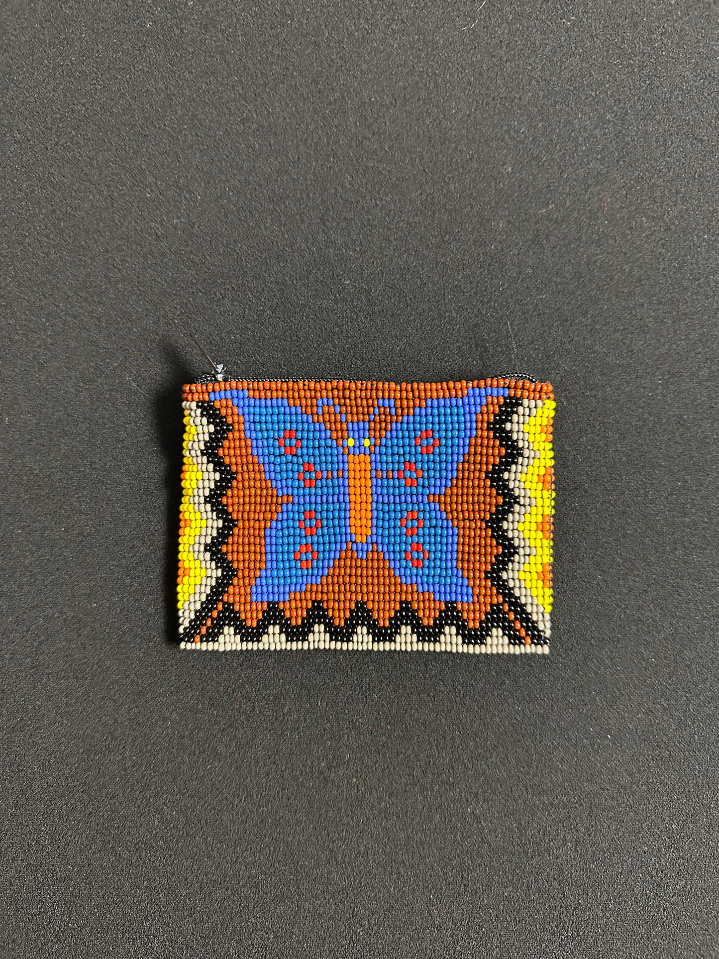 These Guatemalan Hand Beaded Coin Purses are a handcrafted piece of art. Handmade with beads, each purse is lined with a silky nylon lining and closes with a zip-top closure. They are great for organizing items in your purse or bag, and hold credit cards, IDs, metro passes, and change. Perfect for everyday use.