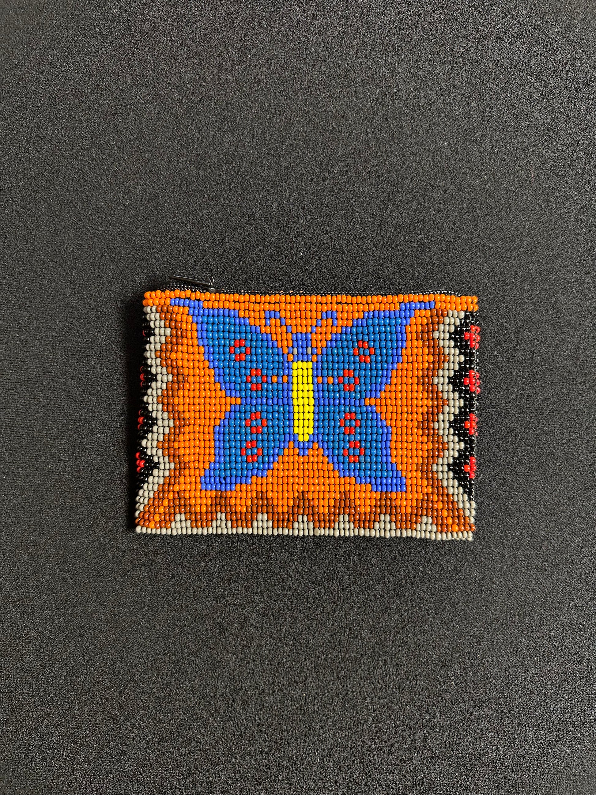 These Guatemalan Hand Beaded Coin Purses are a handcrafted piece of art. Handmade with beads, each purse is lined with a silky nylon lining and closes with a zip-top closure. They are great for organizing items in your purse or bag, and hold credit cards, IDs, metro passes, and change. Perfect for everyday use.