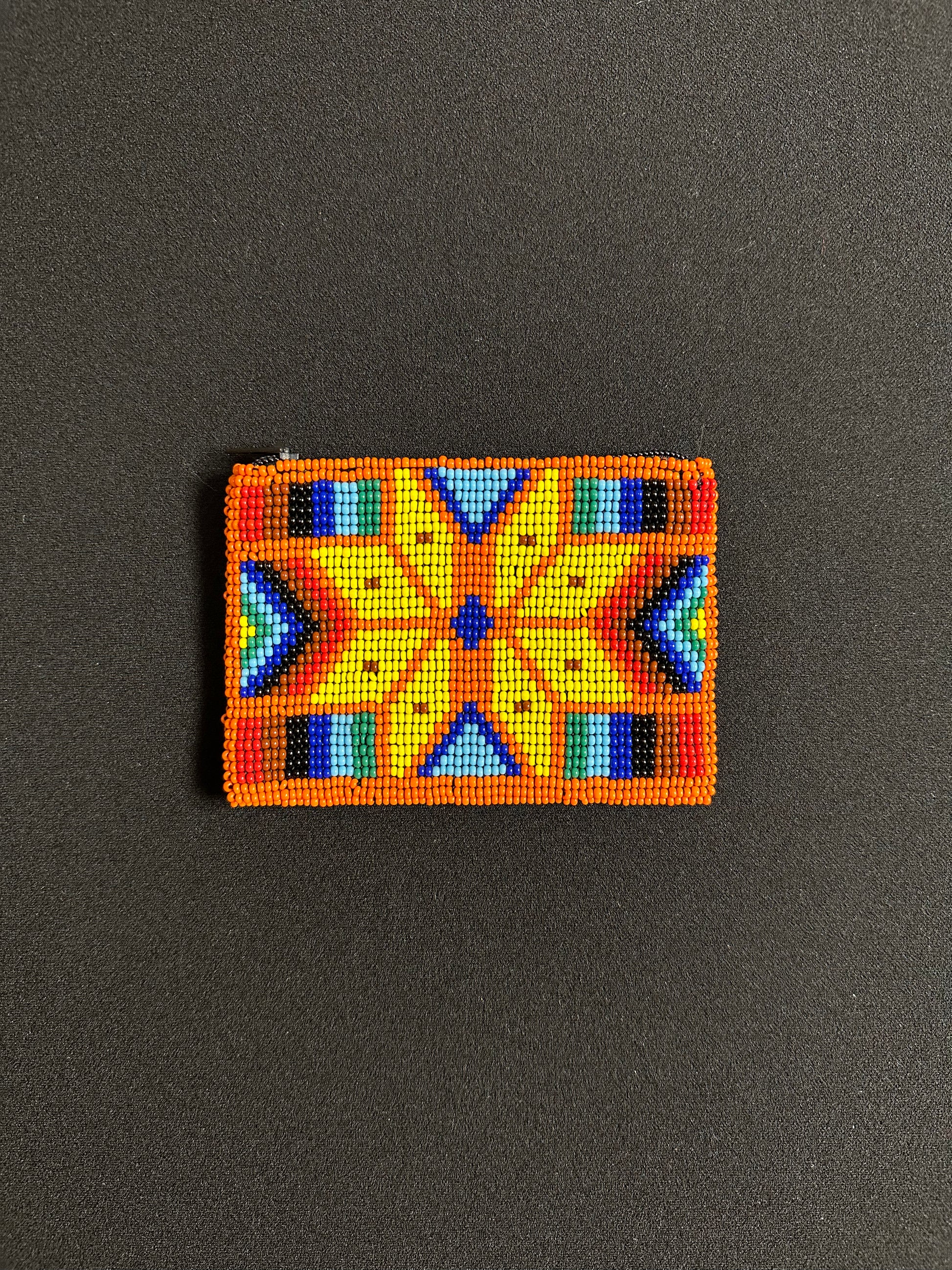 These Guatemalan Hand Beaded Coin Purses are a handcrafted piece of art. Handmade with beads, each purse is lined with a silky nylon lining and closes with a zip-top closure. They are great for organizing items in your purse or bag, and hold credit cards, IDs, metro passes, and change. Perfect for everyday use.