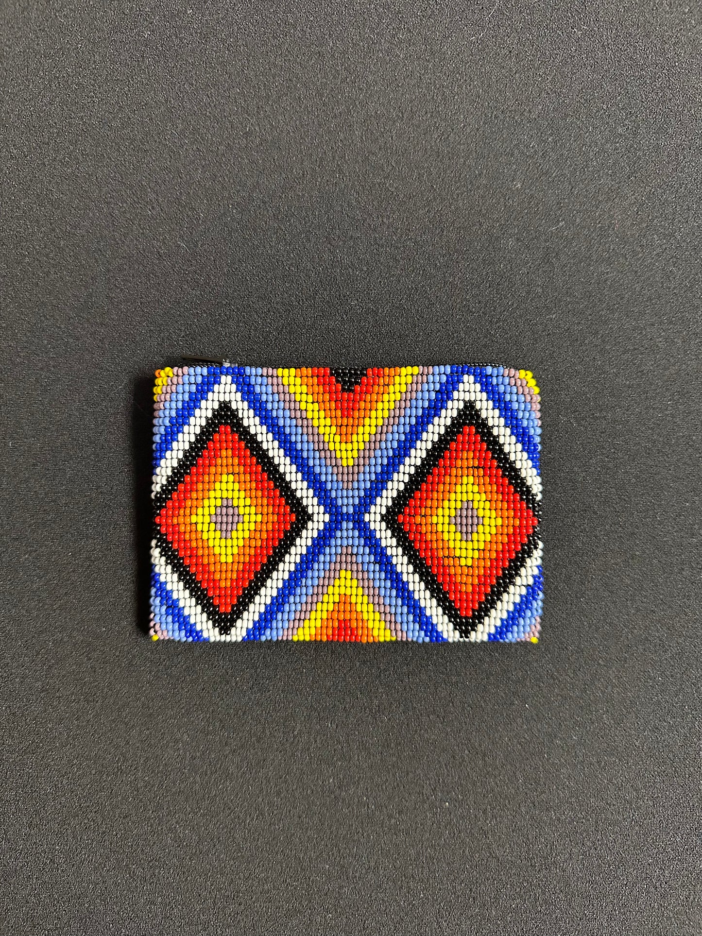 These Guatemalan Hand Beaded Coin Purses are a handcrafted piece of art. Handmade with beads, each purse is lined with a silky nylon lining and closes with a zip-top closure. They are great for organizing items in your purse or bag, and hold credit cards, IDs, metro passes, and change. Perfect for everyday use.