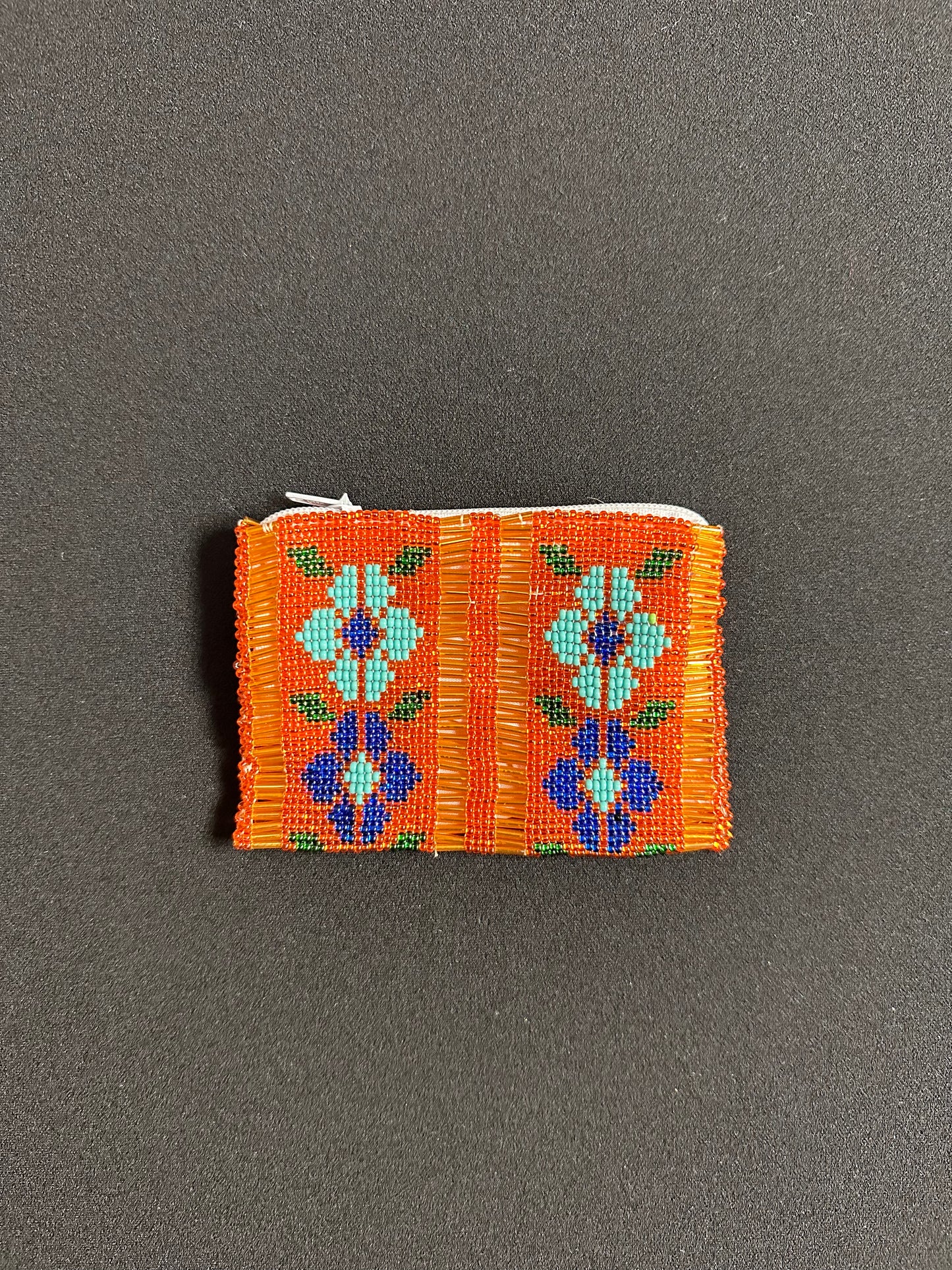 These Guatemalan Hand Beaded Coin Purses are a handcrafted piece of art. Handmade with beads, each purse is lined with a silky nylon lining and closes with a zip-top closure. They are great for organizing items in your purse or bag, and hold credit cards, IDs, metro passes, and change. Perfect for everyday use.