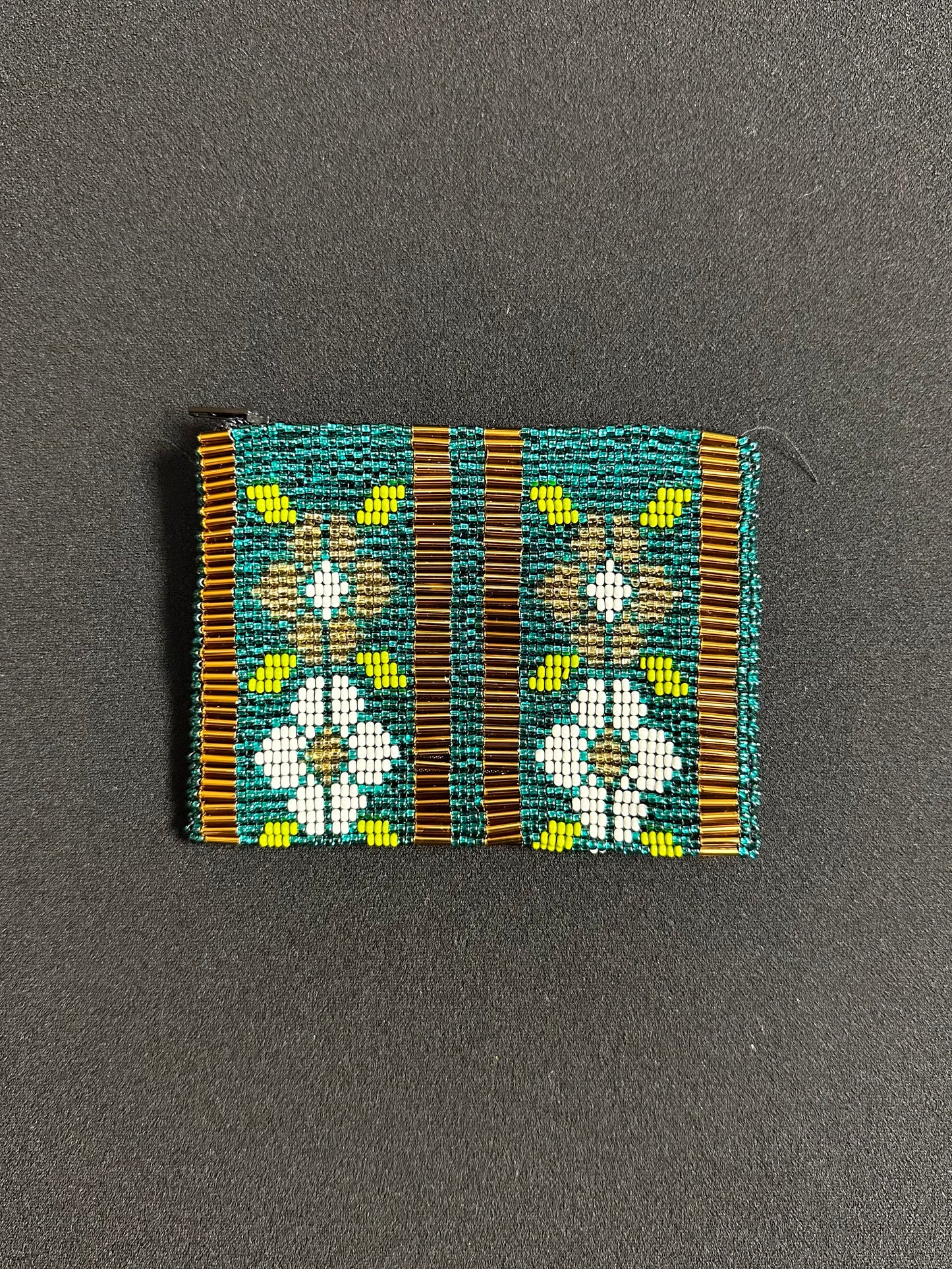 These Guatemalan Hand Beaded Coin Purses are a handcrafted piece of art. Handmade with beads, each purse is lined with a silky nylon lining and closes with a zip-top closure. They are great for organizing items in your purse or bag, and hold credit cards, IDs, metro passes, and change. Perfect for everyday use.