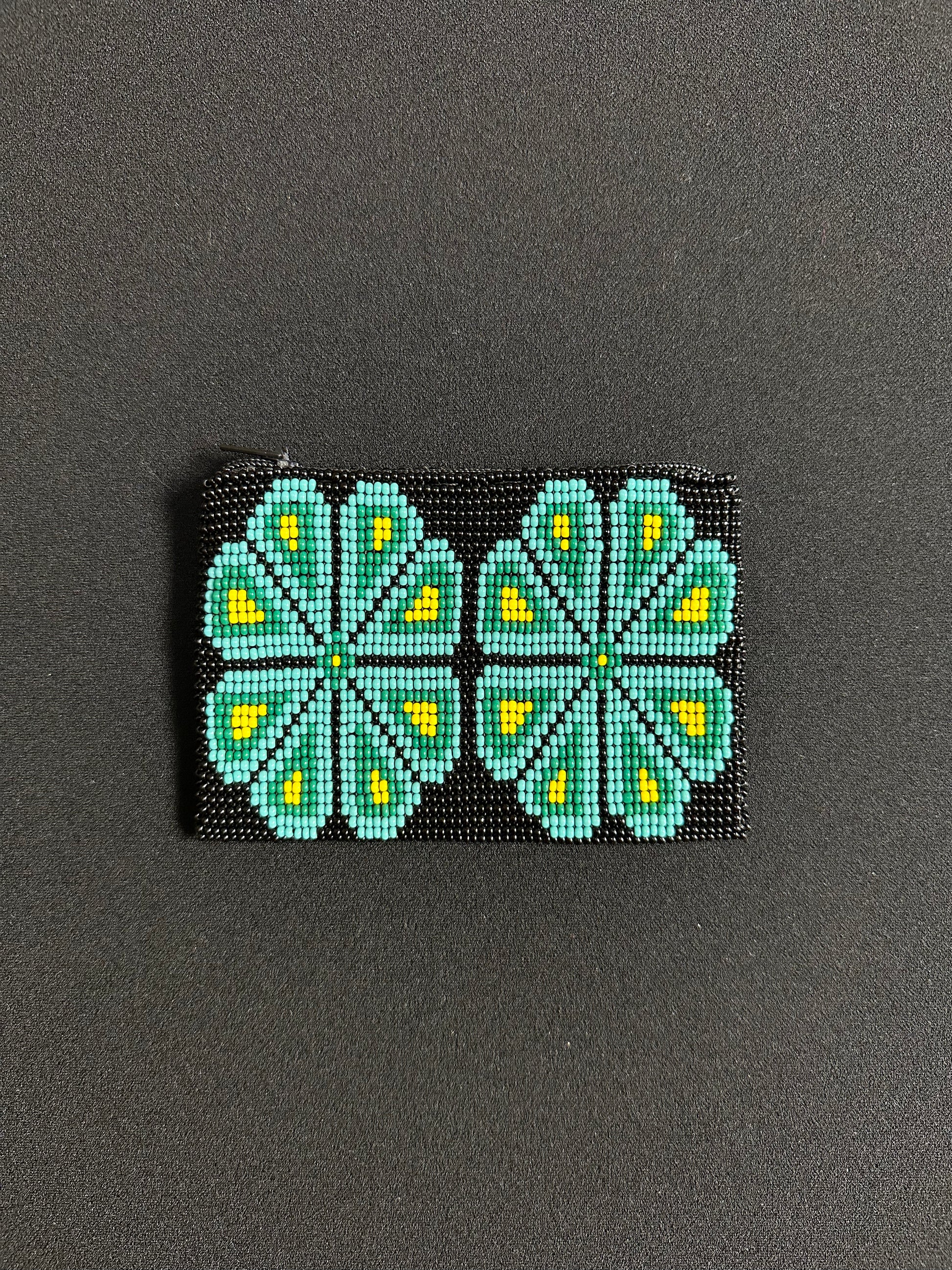 These Guatemalan Hand Beaded Coin Purses are a handcrafted piece of art. Handmade with beads, each purse is lined with a silky nylon lining and closes with a zip-top closure. They are great for organizing items in your purse or bag, and hold credit cards, IDs, metro passes, and change. Perfect for everyday use.