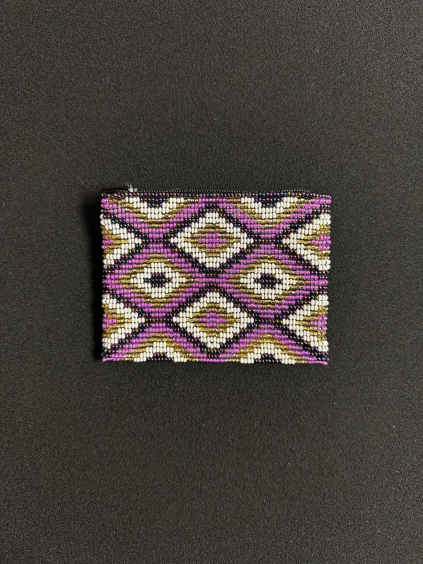 These Guatemalan Hand Beaded Coin Purses are a handcrafted piece of art. Handmade with beads, each purse is lined with a silky nylon lining and closes with a zip-top closure. They are great for organizing items in your purse or bag, and hold credit cards, IDs, metro passes, and change. Perfect for everyday use.