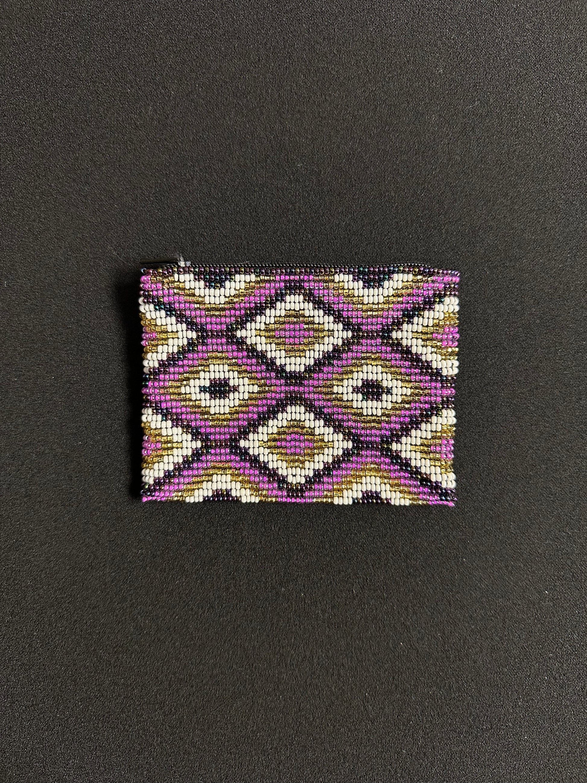 These Guatemalan Hand Beaded Coin Purses are a handcrafted piece of art. Handmade with beads, each purse is lined with a silky nylon lining and closes with a zip-top closure. They are great for organizing items in your purse or bag, and hold credit cards, IDs, metro passes, and change. Perfect for everyday use.