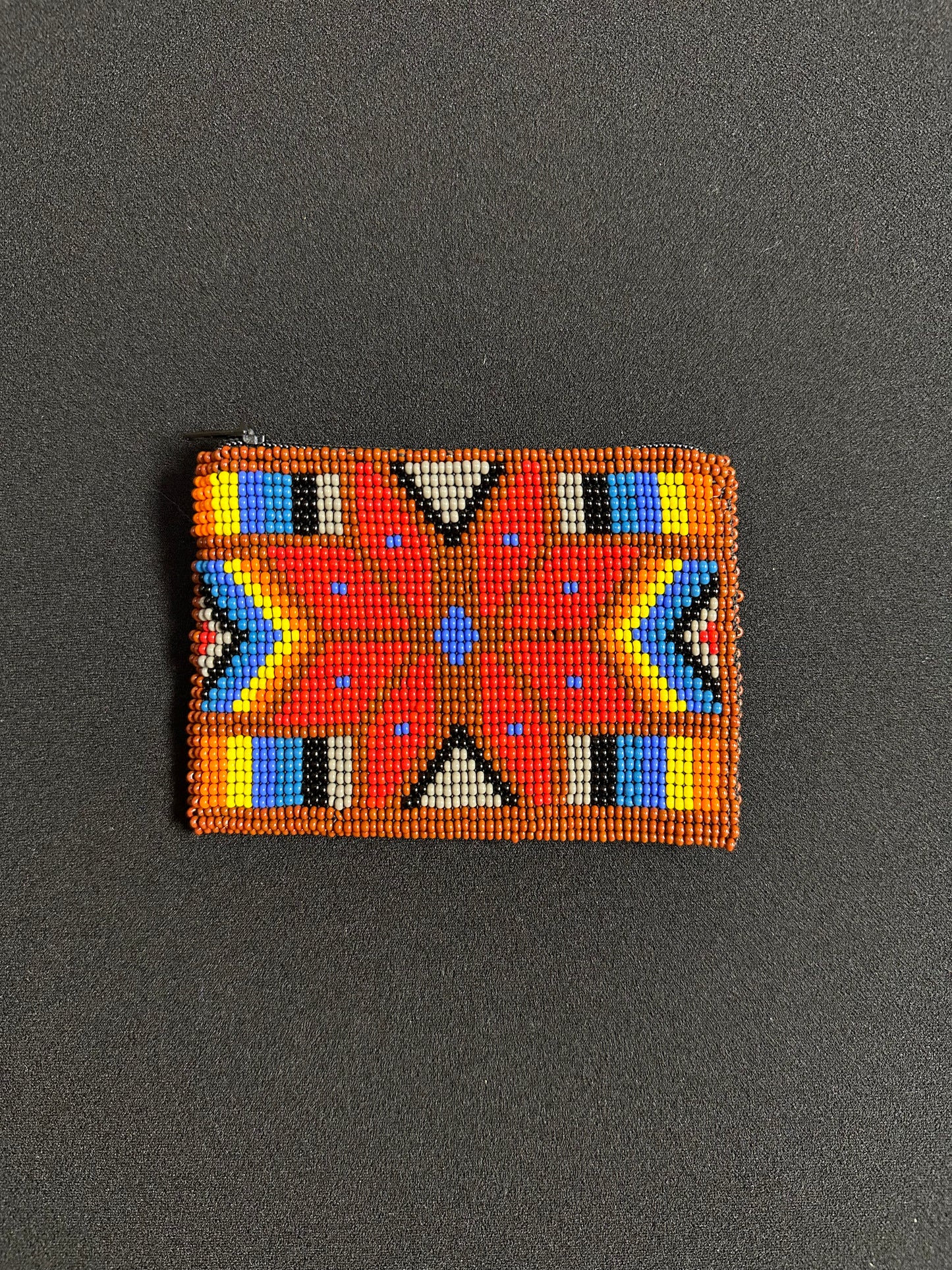 These Guatemalan Hand Beaded Coin Purses are a handcrafted piece of art. Handmade with beads, each purse is lined with a silky nylon lining and closes with a zip-top closure. They are great for organizing items in your purse or bag, and hold credit cards, IDs, metro passes, and change. Perfect for everyday use.