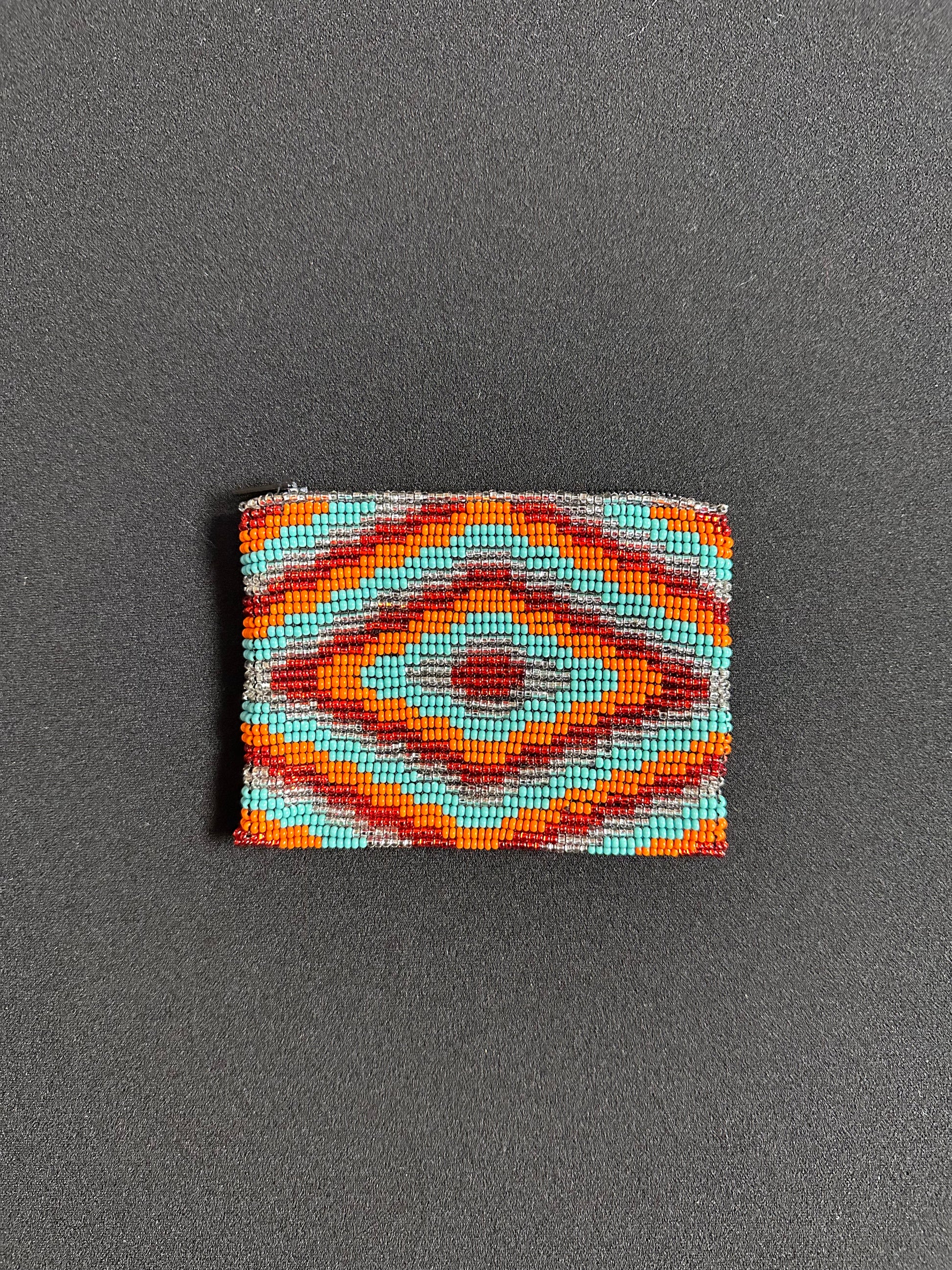 These Guatemalan Hand Beaded Coin Purses are a handcrafted piece of art. Handmade with beads, each purse is lined with a silky nylon lining and closes with a zip-top closure. They are great for organizing items in your purse or bag, and hold credit cards, IDs, metro passes, and change. Perfect for everyday use.