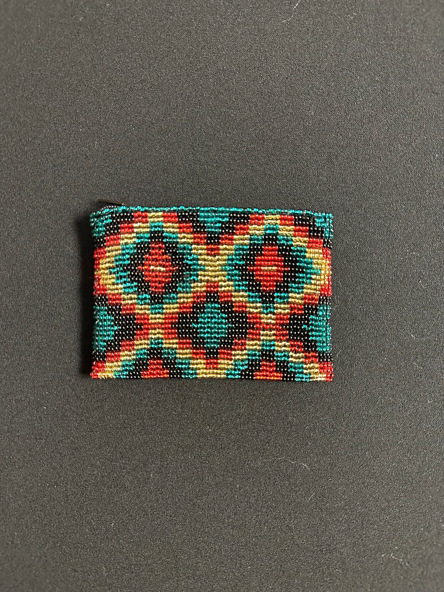 These Guatemalan Hand Beaded Coin Purses are a handcrafted piece of art. Handmade with beads, each purse is lined with a silky nylon lining and closes with a zip-top closure. They are great for organizing items in your purse or bag, and hold credit cards, IDs, metro passes, and change. Perfect for everyday use.