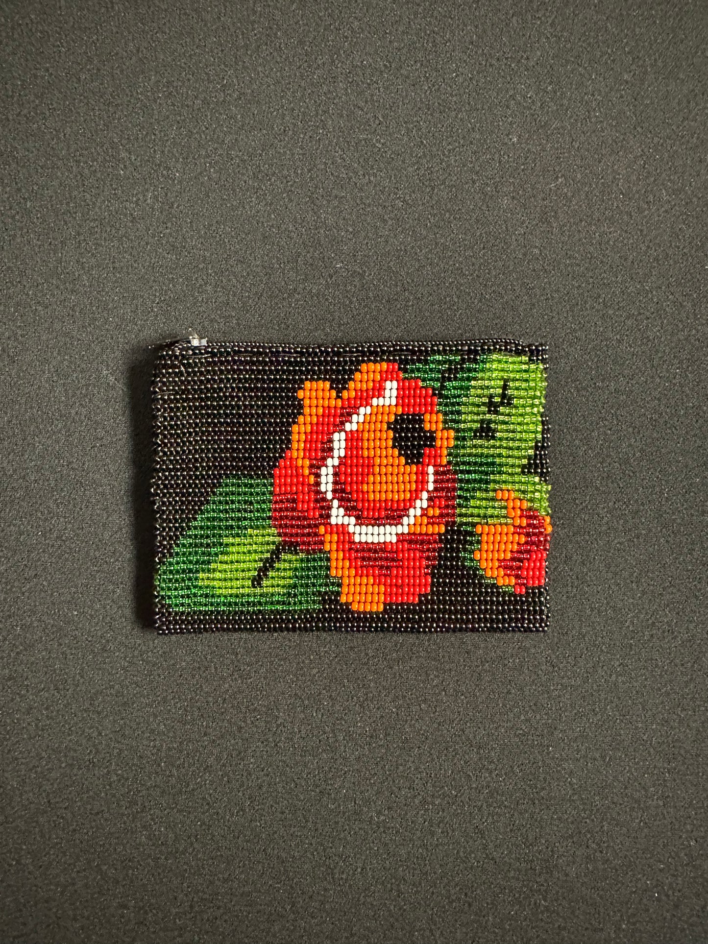 These Guatemalan Hand Beaded Coin Purses are a handcrafted piece of art. Handmade with beads, each purse is lined with a silky nylon lining and closes with a zip-top closure. They are great for organizing items in your purse or bag, and hold credit cards, IDs, metro passes, and change. Perfect for everyday use.