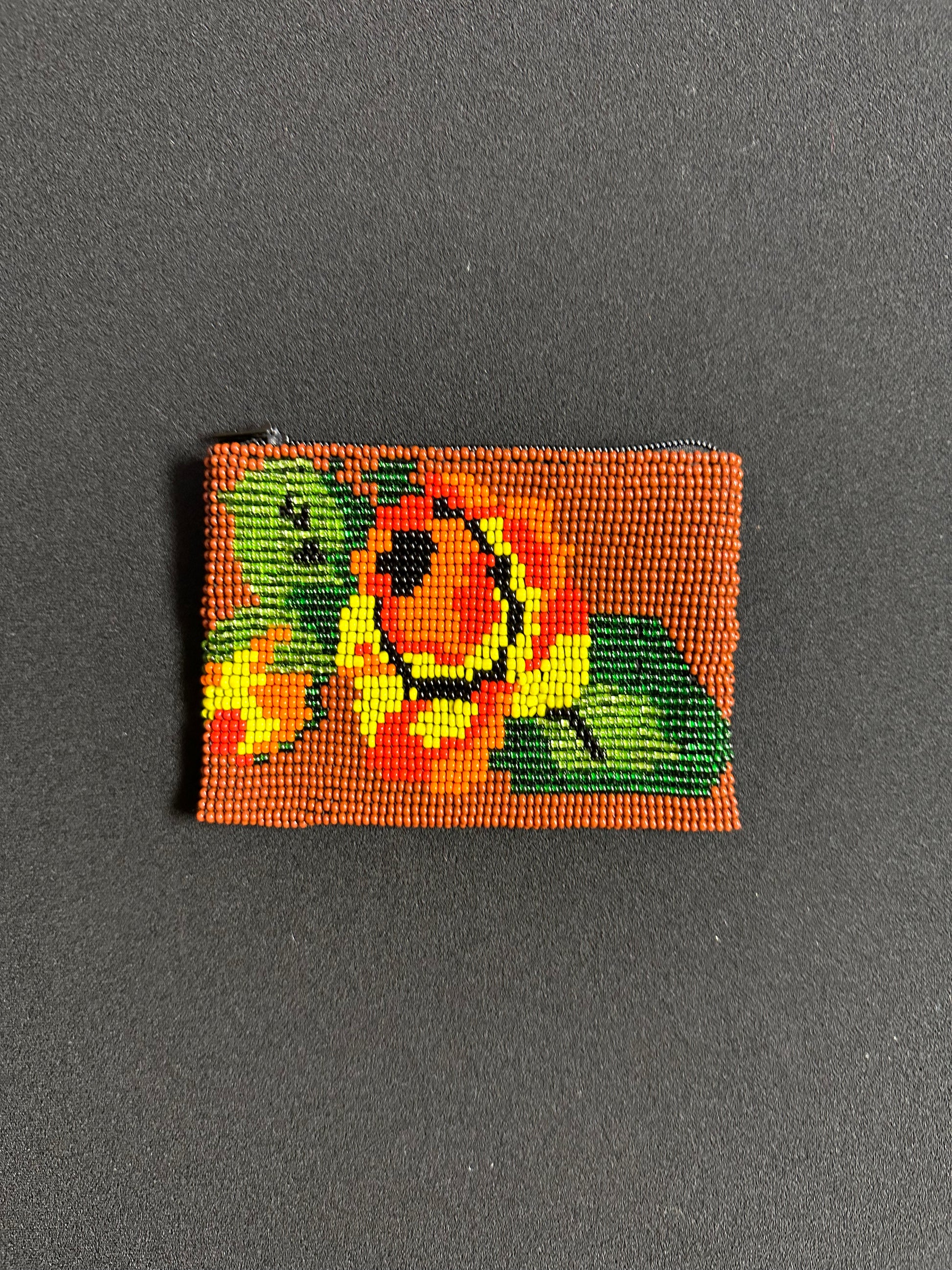 These Guatemalan Hand Beaded Coin Purses are a handcrafted piece of art. Handmade with beads, each purse is lined with a silky nylon lining and closes with a zip-top closure. They are great for organizing items in your purse or bag, and hold credit cards, IDs, metro passes, and change. Perfect for everyday use.