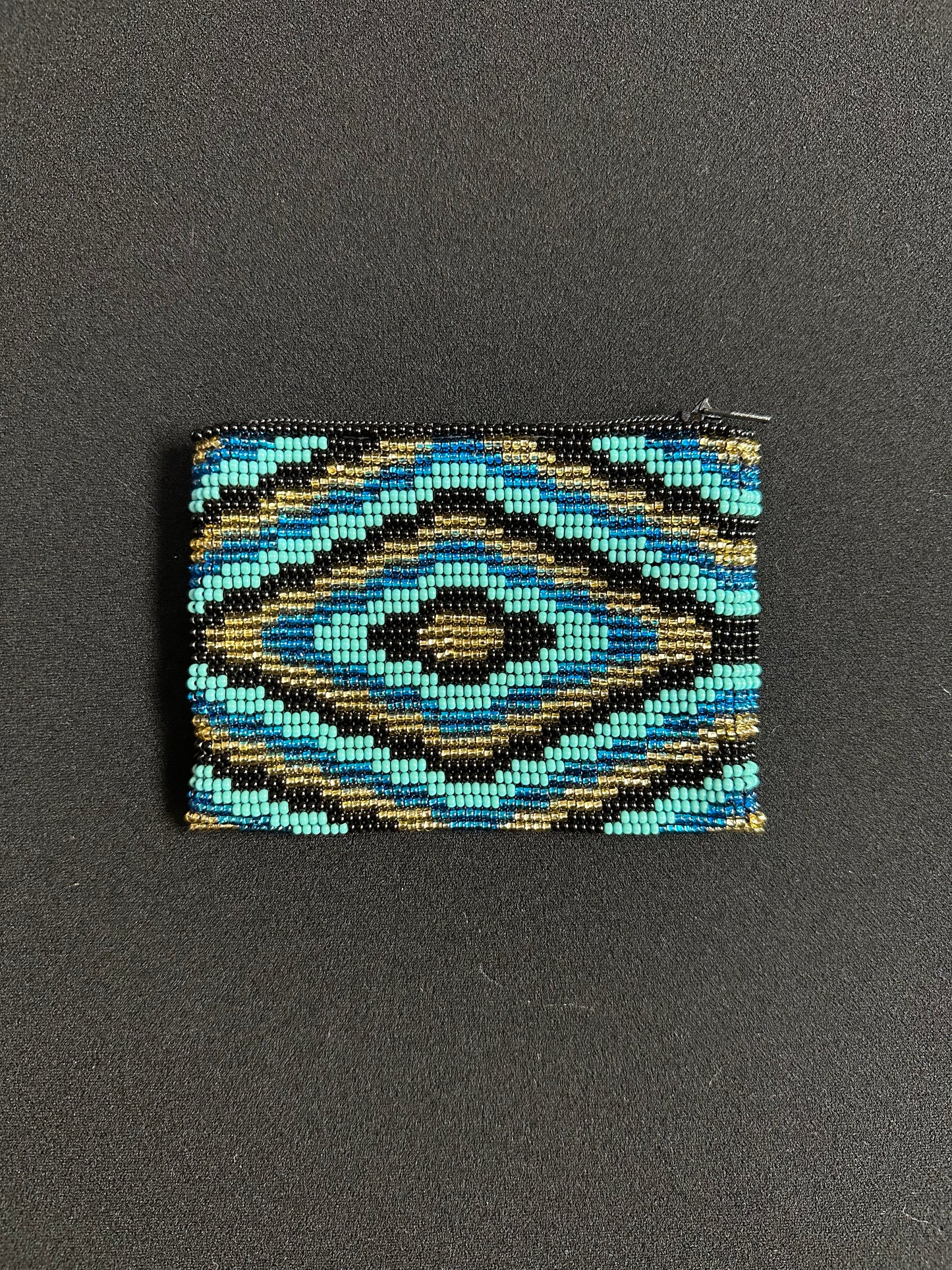 These Guatemalan Hand Beaded Coin Purses are a handcrafted piece of art. Handmade with beads, each purse is lined with a silky nylon lining and closes with a zip-top closure. They are great for organizing items in your purse or bag, and hold credit cards, IDs, metro passes, and change. Perfect for everyday use.