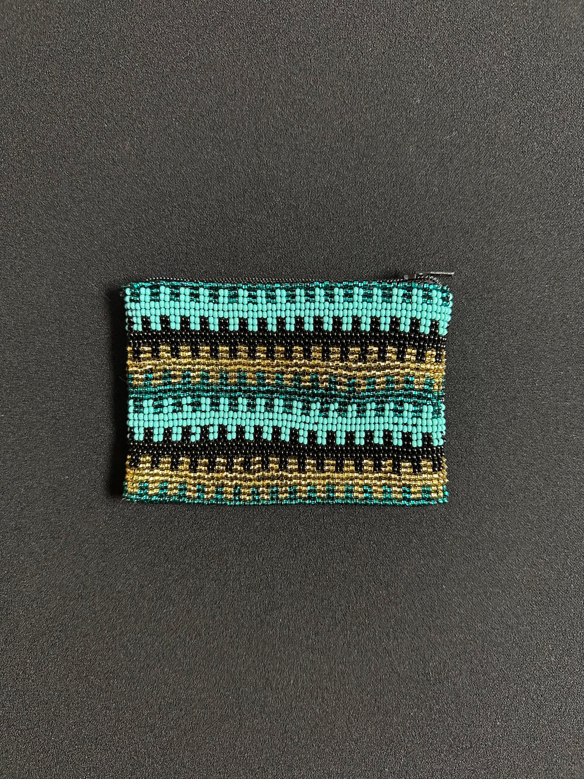 These Guatemalan Hand Beaded Coin Purses are a handcrafted piece of art. Handmade with beads, each purse is lined with a silky nylon lining and closes with a zip-top closure. They are great for organizing items in your purse or bag, and hold credit cards, IDs, metro passes, and change. Perfect for everyday use.