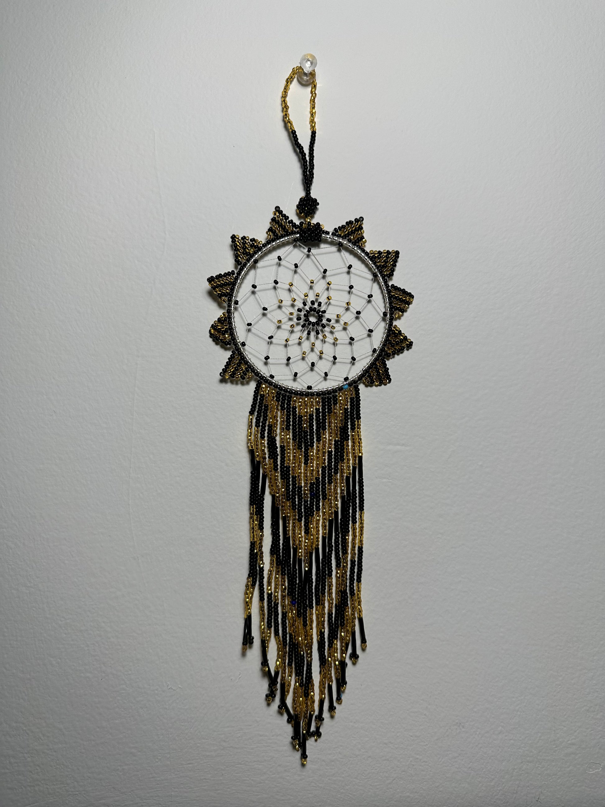 These dream catchers are a beaded hanging ornament, It is handmade and perfect for a wall or for a rear view mirror. This dream catcher is made by a Mayan Family, from beading artists in Santiago La Laguna in rural Guatemala. Indigenous motifs worked in colorful seed beads embellish the dream catcher. Bead work is relatively new in Guatemala, but the impact of its trade makes a tremendous positive difference in the lives of the indigenous women who have learned this intricate skill.