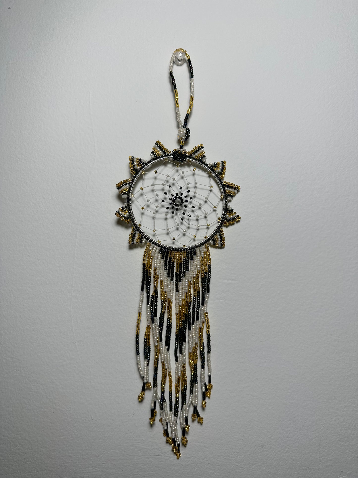 These dream catchers are a beaded hanging ornament, It is handmade and perfect for a wall or for a rear view mirror. This dream catcher is made by a Mayan Family, from beading artists in Santiago La Laguna in rural Guatemala. Indigenous motifs worked in colorful seed beads embellish the dream catcher. Bead work is relatively new in Guatemala, but the impact of its trade makes a tremendous positive difference in the lives of the indigenous women who have learned this intricate skill.