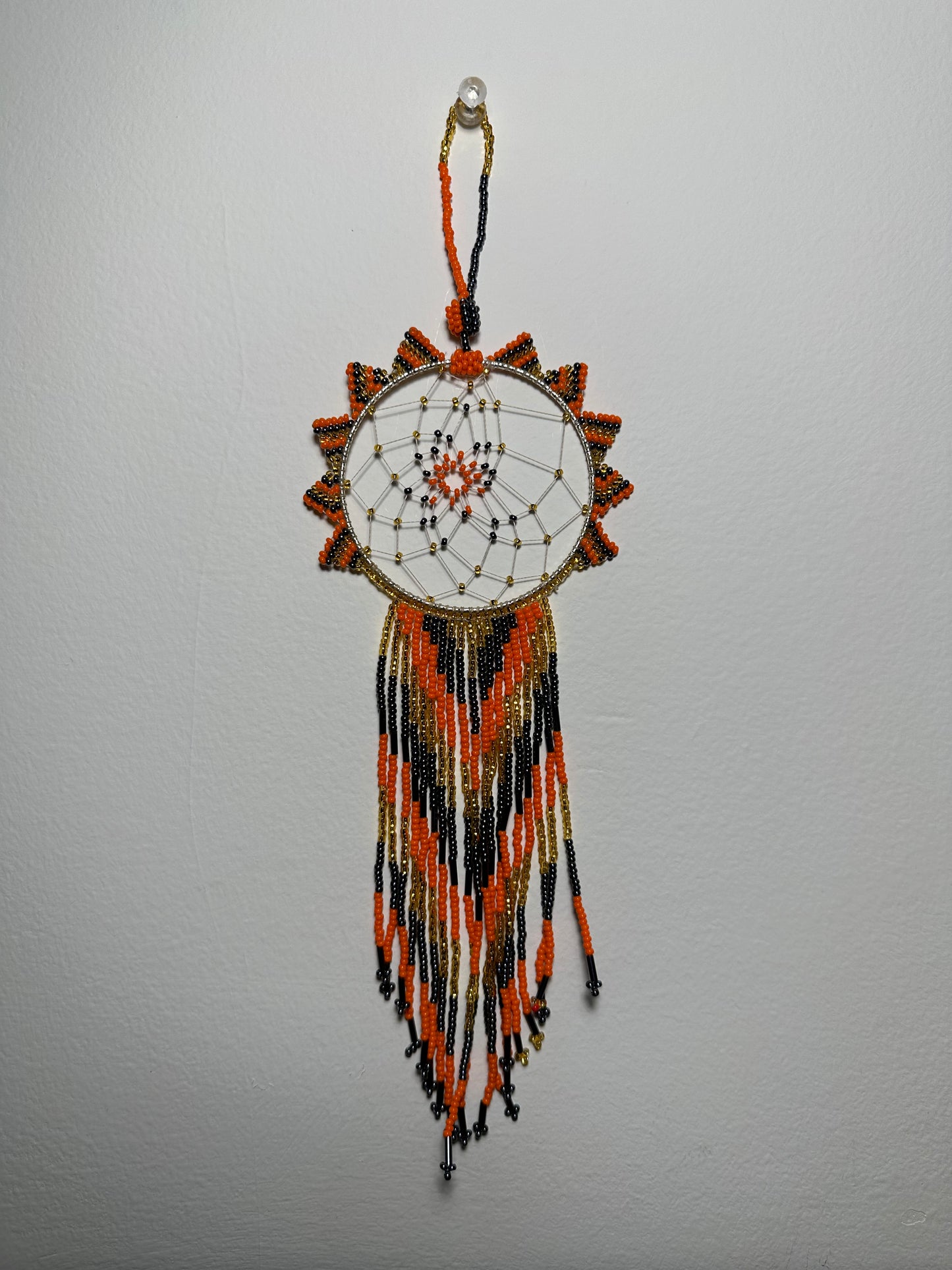 These dream catchers are a beaded hanging ornament, It is handmade and perfect for a wall or for a rear view mirror. This dream catcher is made by a Mayan Family, from beading artists in Santiago La Laguna in rural Guatemala. Indigenous motifs worked in colorful seed beads embellish the dream catcher. Bead work is relatively new in Guatemala, but the impact of its trade makes a tremendous positive difference in the lives of the indigenous women who have learned this intricate skill.