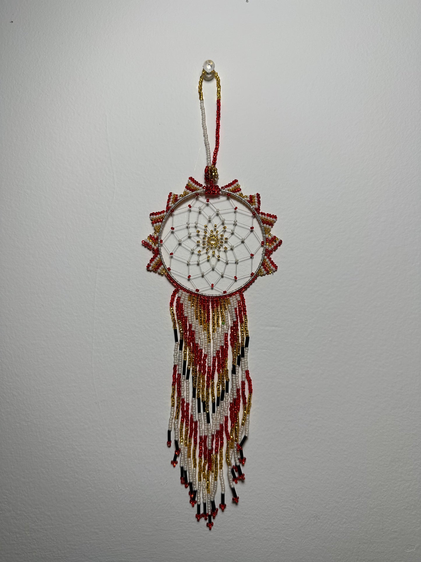 These dream catchers are a beaded hanging ornament, It is handmade and perfect for a wall or for a rear view mirror. This dream catcher is made by a Mayan Family, from beading artists in Santiago La Laguna in rural Guatemala. Indigenous motifs worked in colorful seed beads embellish the dream catcher. Bead work is relatively new in Guatemala, but the impact of its trade makes a tremendous positive difference in the lives of the indigenous women who have learned this intricate skill.