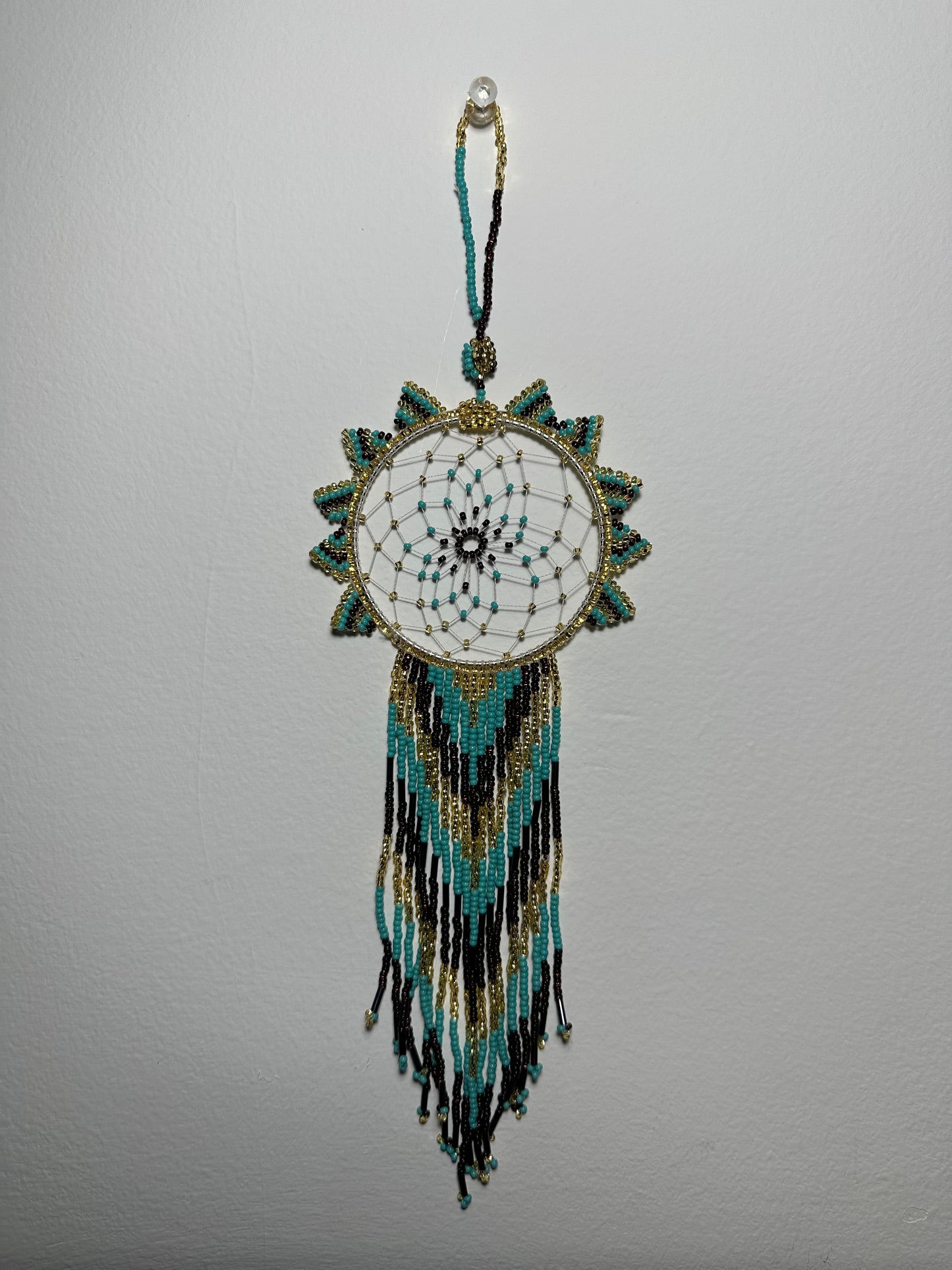 These dream catchers are a beaded hanging ornament, It is handmade and perfect for a wall or for a rear view mirror. This dream catcher is made by a Mayan Family, from beading artists in Santiago La Laguna in rural Guatemala. Indigenous motifs worked in colorful seed beads embellish the dream catcher. Bead work is relatively new in Guatemala, but the impact of its trade makes a tremendous positive difference in the lives of the indigenous women who have learned this intricate skill.