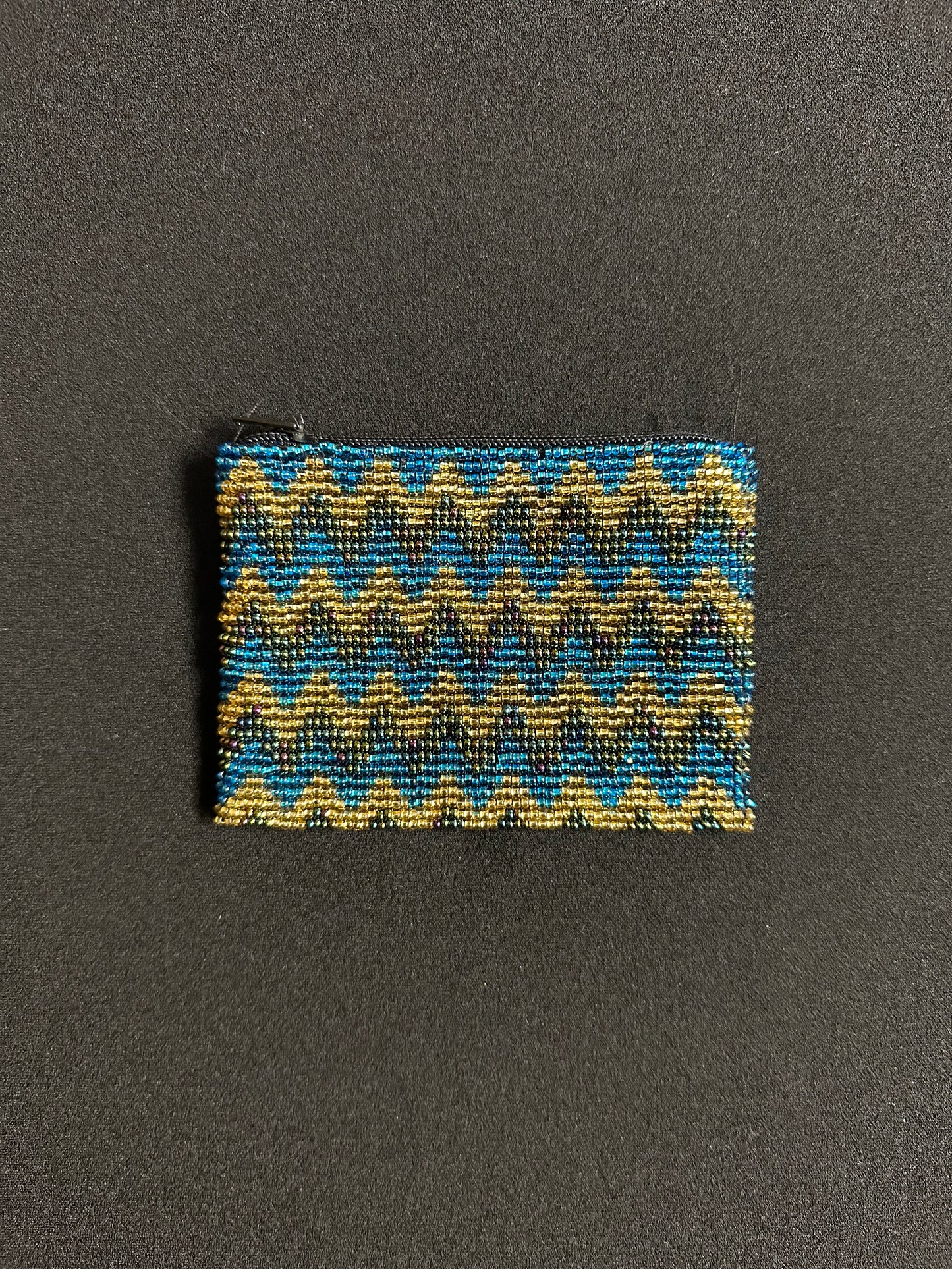 These Guatemalan Hand Beaded Coin Purses are a handcrafted piece of art. Handmade with beads, each purse is lined with a silky nylon lining and closes with a zip-top closure. They are great for organizing items in your purse or bag, and hold credit cards, IDs, metro passes, and change. Perfect for everyday use.