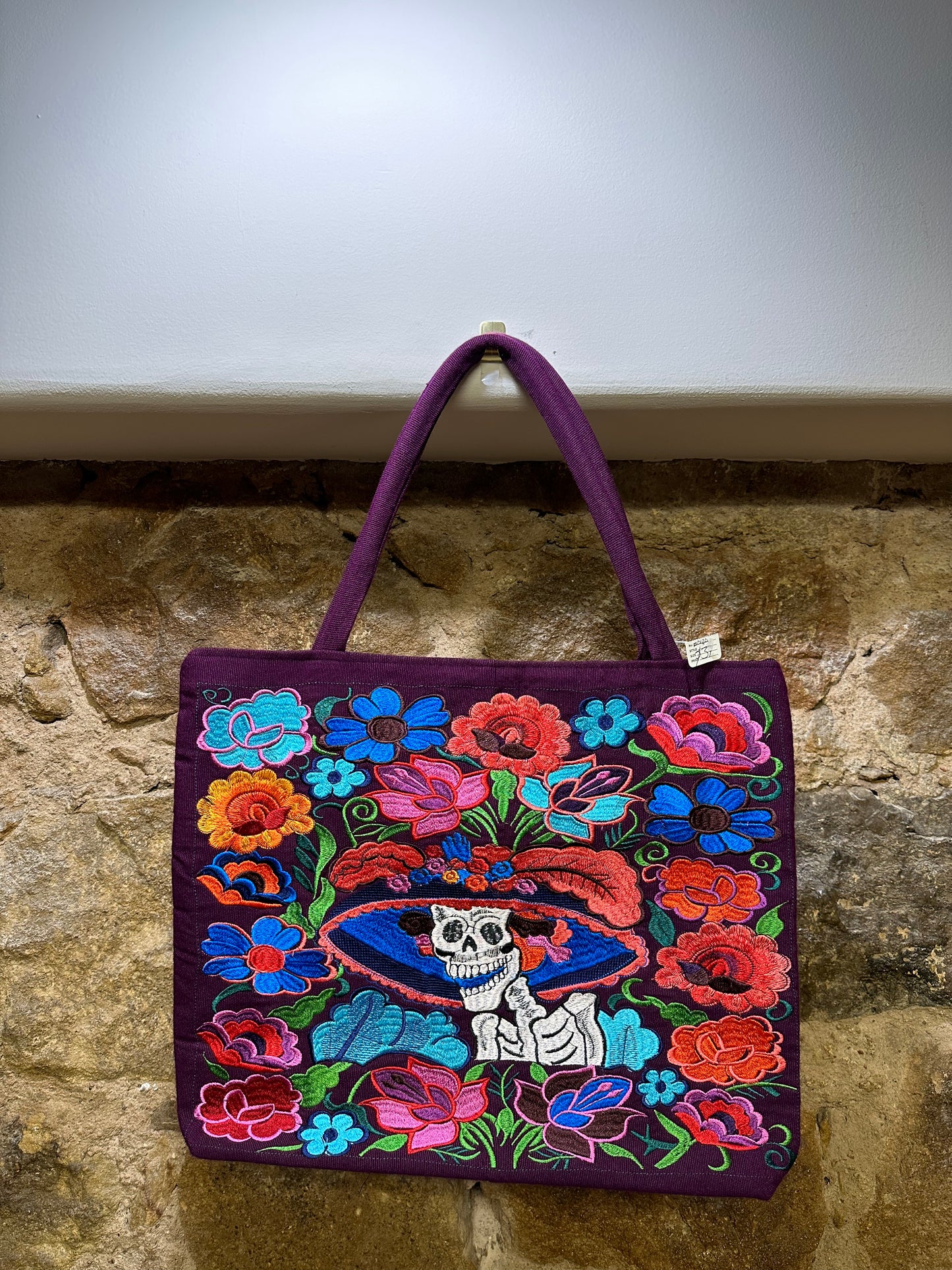 Artisanal Embroidered Purse:  These beautiful embroidered bags can be used for an evening get-together as it can for a day spent shopping with friends. The extraordinary embroidery adds interest and color to any outfit. Roomy, practical and dressy all describe this bag perfectly. The purse has a top zipper, inside liner, two small back pockets with zipper and plenty of room. The embroidery is done in the front of the purse, the back is a solid color. They come in different embroidered designs and colors