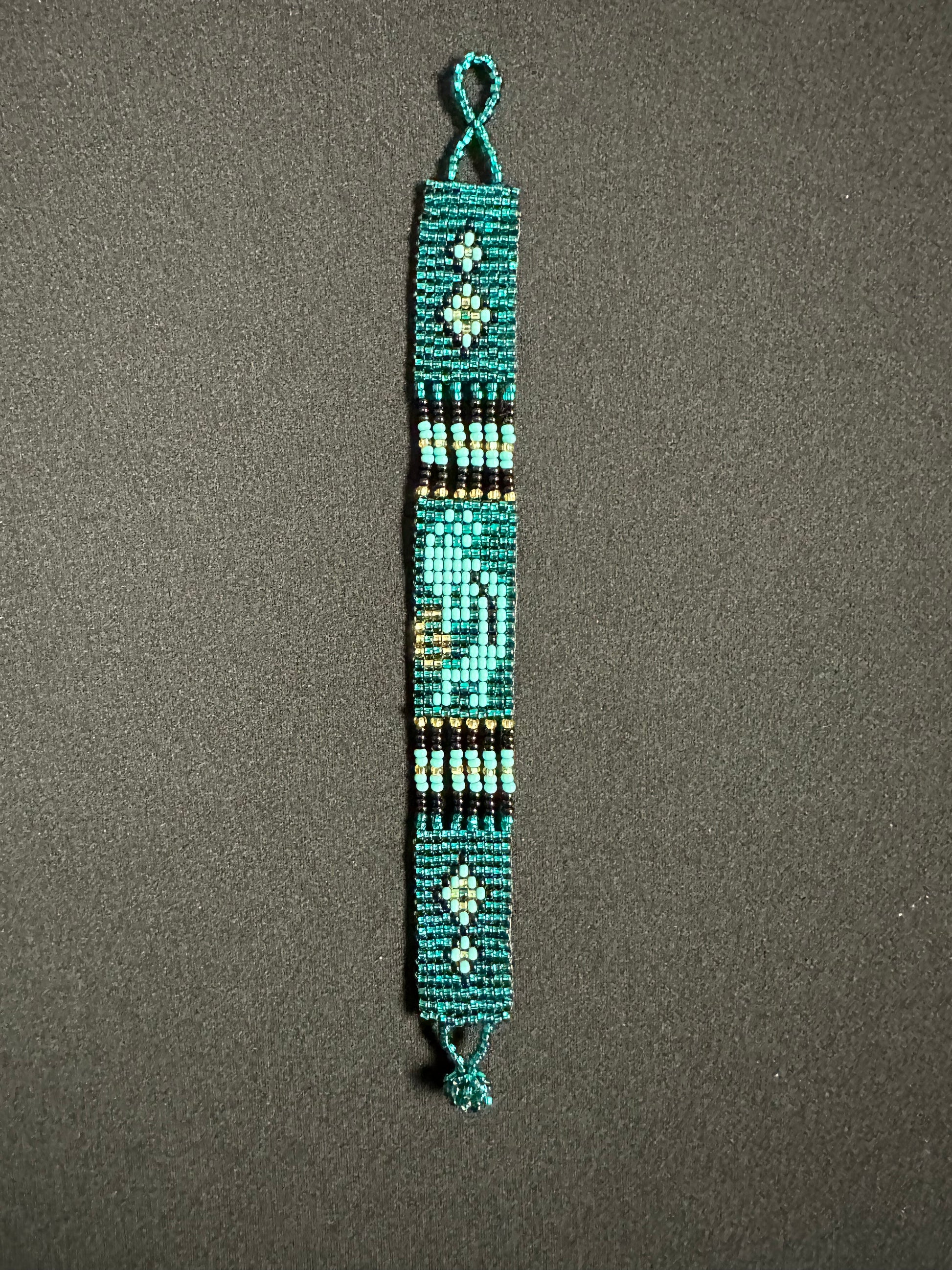 This beautiful hand-made Guatemalan accessory is a great addition to any jewelry collection! The bracelet boasts fun, vibrant colors inspired by the vibrant palette of the native culture. It's sure to turn heads with its unique design and beautiful hues. Add a bit of fun and excitement to your look with the Kokopelli Design Bracelet!