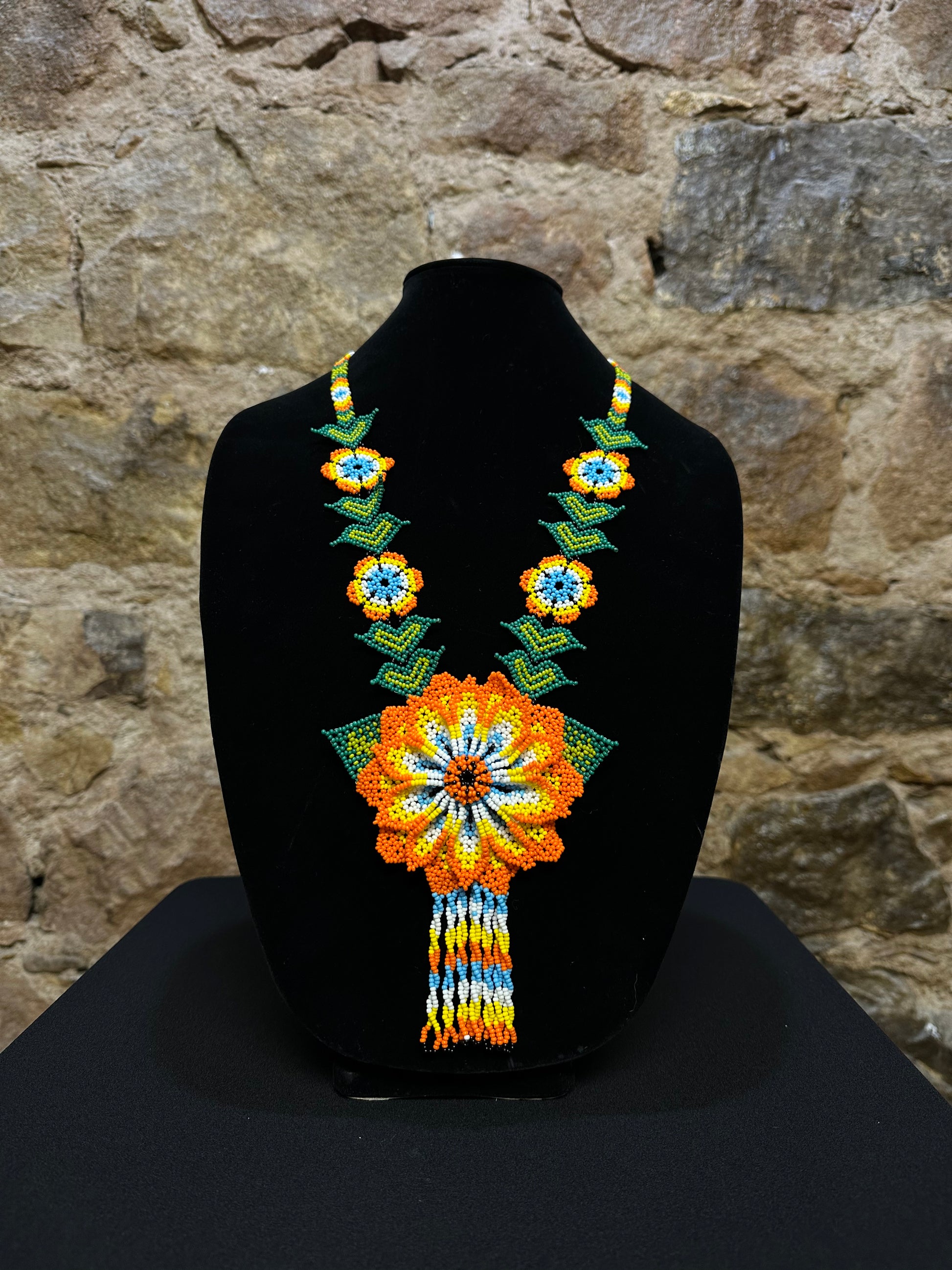 This beautiful and handmade floral beaded necklace is the perfect way to accessorize any outfit. It's colorful beadwork creates a three dimensional stunning flower motif, and you'll love how it brings a touch of fun and cheer to your style. Handcrafted with lots of attention to detail, this beaded necklace is sure to become your favorite accessory!