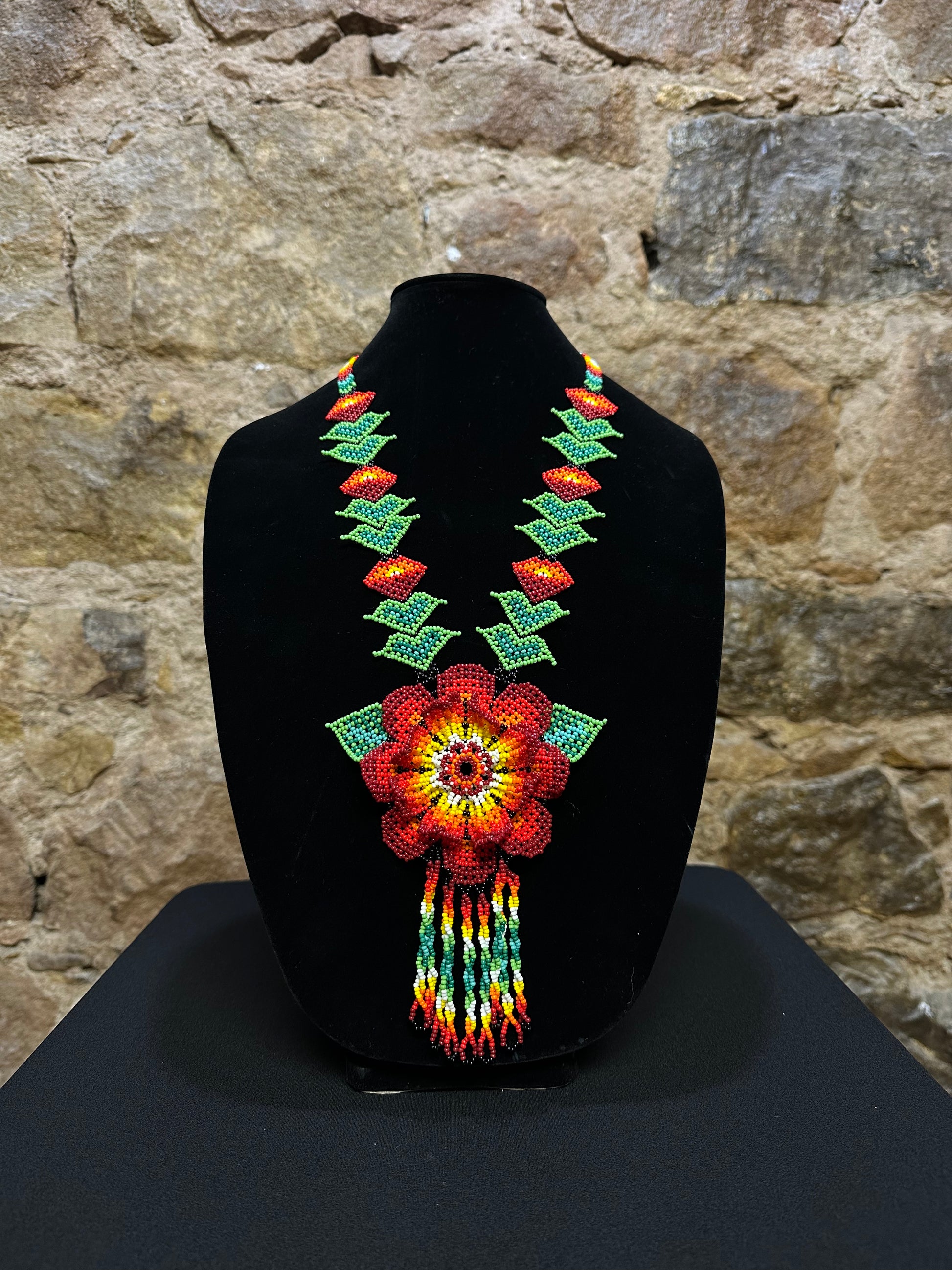 This beautiful and handmade floral beaded necklace is the perfect way to accessorize any outfit. It's colorful beadwork creates a three dimensional stunning flower motif, and you'll love how it brings a touch of fun and cheer to your style. Handcrafted with lots of attention to detail, this beaded necklace is sure to become your favorite accessory!