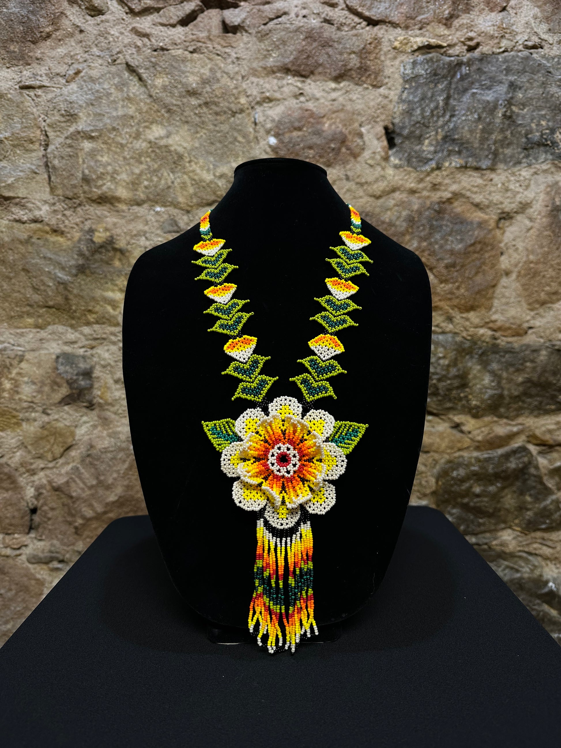 This beautiful and handmade floral beaded necklace is the perfect way to accessorize any outfit. It's colorful beadwork creates a three dimensional stunning flower motif, and you'll love how it brings a touch of fun and cheer to your style. Handcrafted with lots of attention to detail, this beaded necklace is sure to become your favorite accessory!