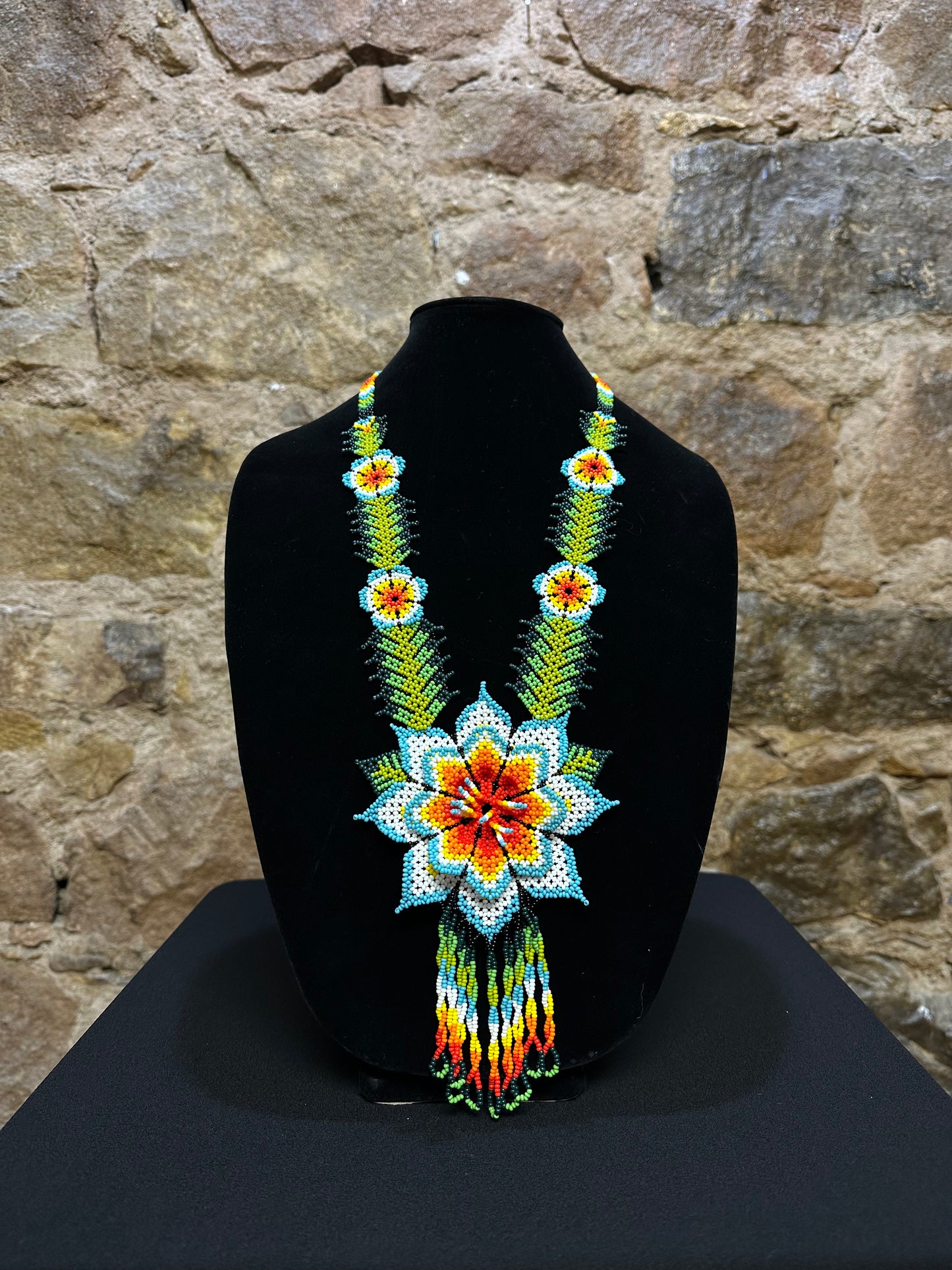 This beautiful and handmade floral beaded necklace is the perfect way to accessorize any outfit. It's colorful beadwork creates a three dimensional stunning flower motif, and you'll love how it brings a touch of fun and cheer to your style. Handcrafted with lots of attention to detail, this beaded necklace is sure to become your favorite accessory!