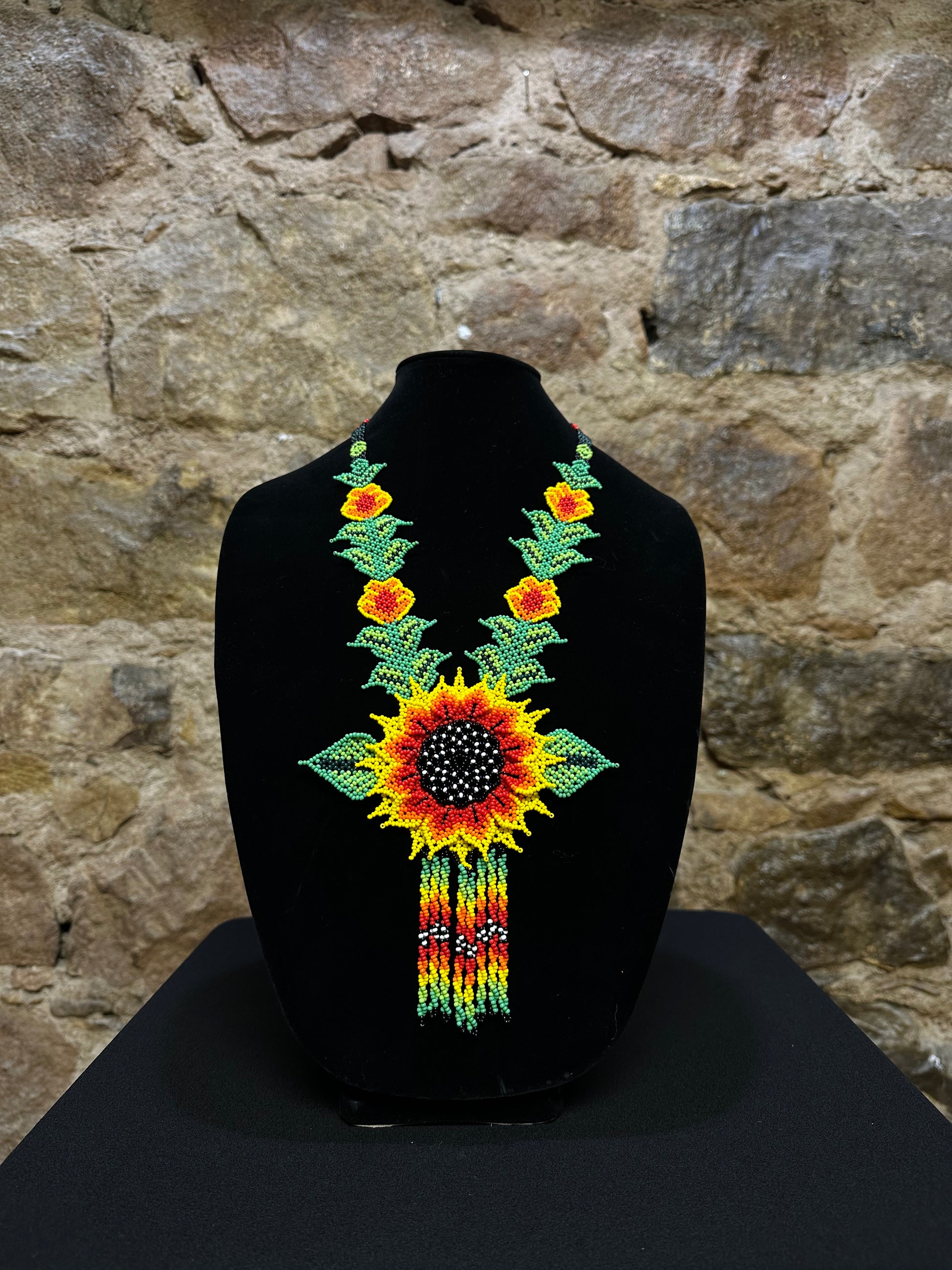 This beautiful and handmade floral beaded necklace is the perfect way to accessorize any outfit. It's colorful beadwork creates a three dimensional stunning flower motif, and you'll love how it brings a touch of fun and cheer to your style. Handcrafted with lots of attention to detail, this beaded necklace is sure to become your favorite accessory!