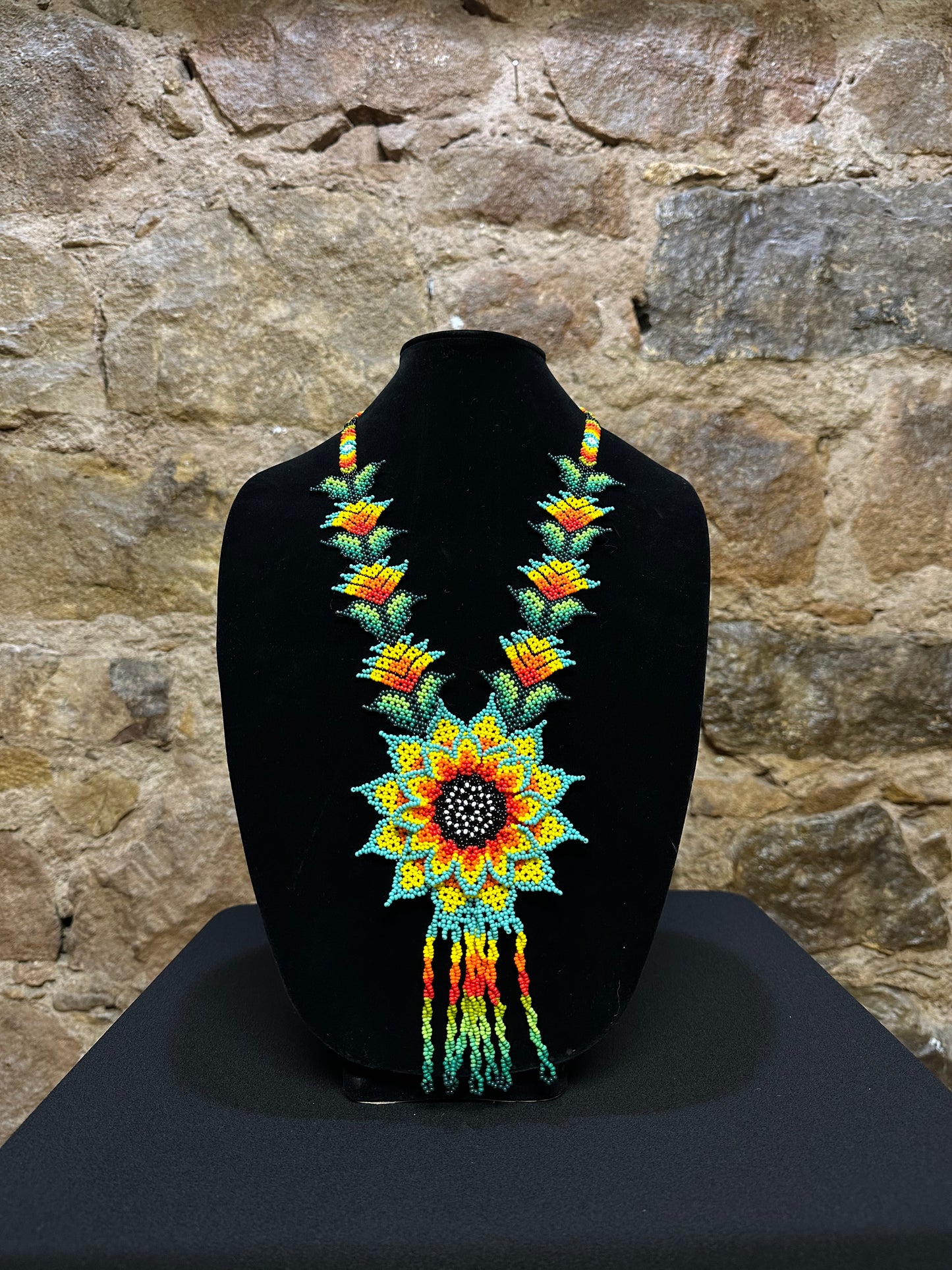 This beautiful and handmade floral beaded necklace is the perfect way to accessorize any outfit. It's colorful beadwork creates a three dimensional stunning flower motif, and you'll love how it brings a touch of fun and cheer to your style. Handcrafted with lots of attention to detail, this beaded necklace is sure to become your favorite accessory!