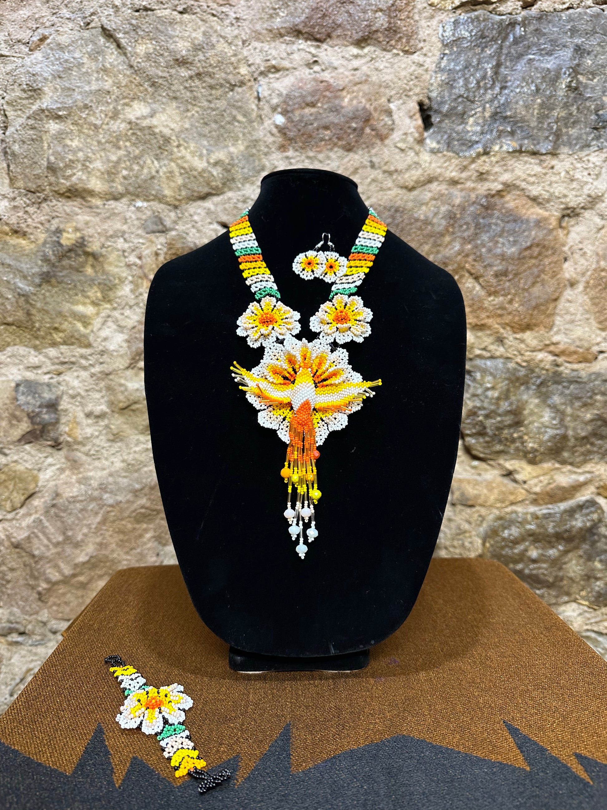 Make a vibrant statement with this handmade Floral Hummingbird Necklace and Earring Set. Crafted with colorful beads, it features a three-dimensional hummingbird motif with intricate detail. Whether you choose to make a statement at a special occasion or just want to add a touch of elegance to your casual look, this set won’t disappoint. With the perfect combination of charm and beauty, this one-of-a-kind set is sure to complement any ensemble.