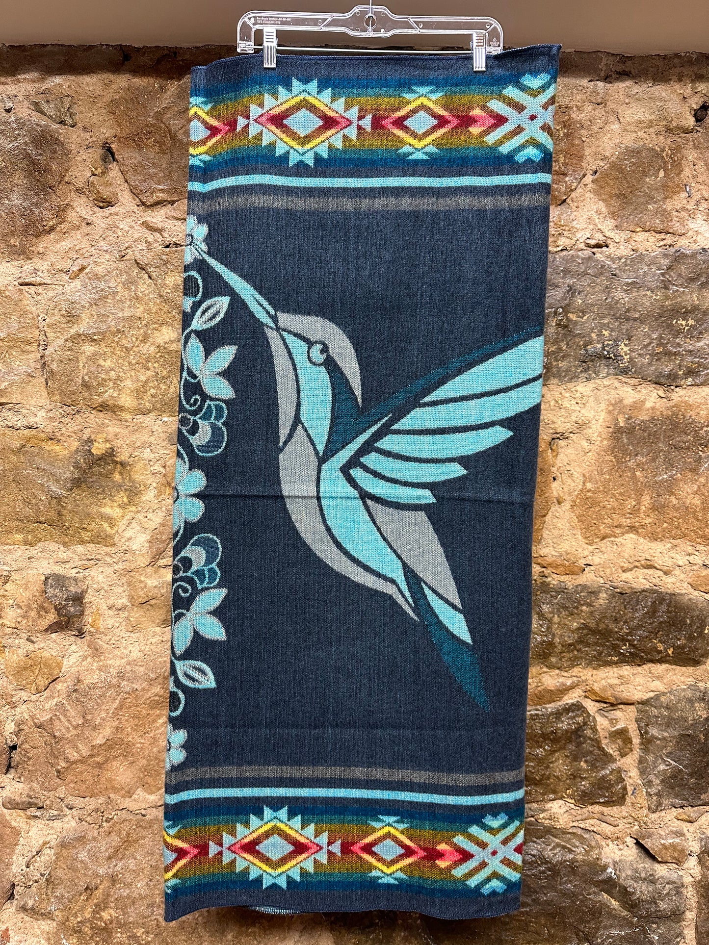 This cozy hummingbird blanket, made in Ecuador, is perfect for snuggling up this winter season! It's soft with a blend of 70% wool and 30% acrylic, keeping you warm and snug wherever you go. Whether you’re cuddling on the sofa, joining a campfire, or just taking an evening stroll, the hummingbird blanket will be the perfect companion and make the experience so much more enjoyable. With its unique design and delicate touch, this fun and festive blanket is sure to be the perfect addition to your home.