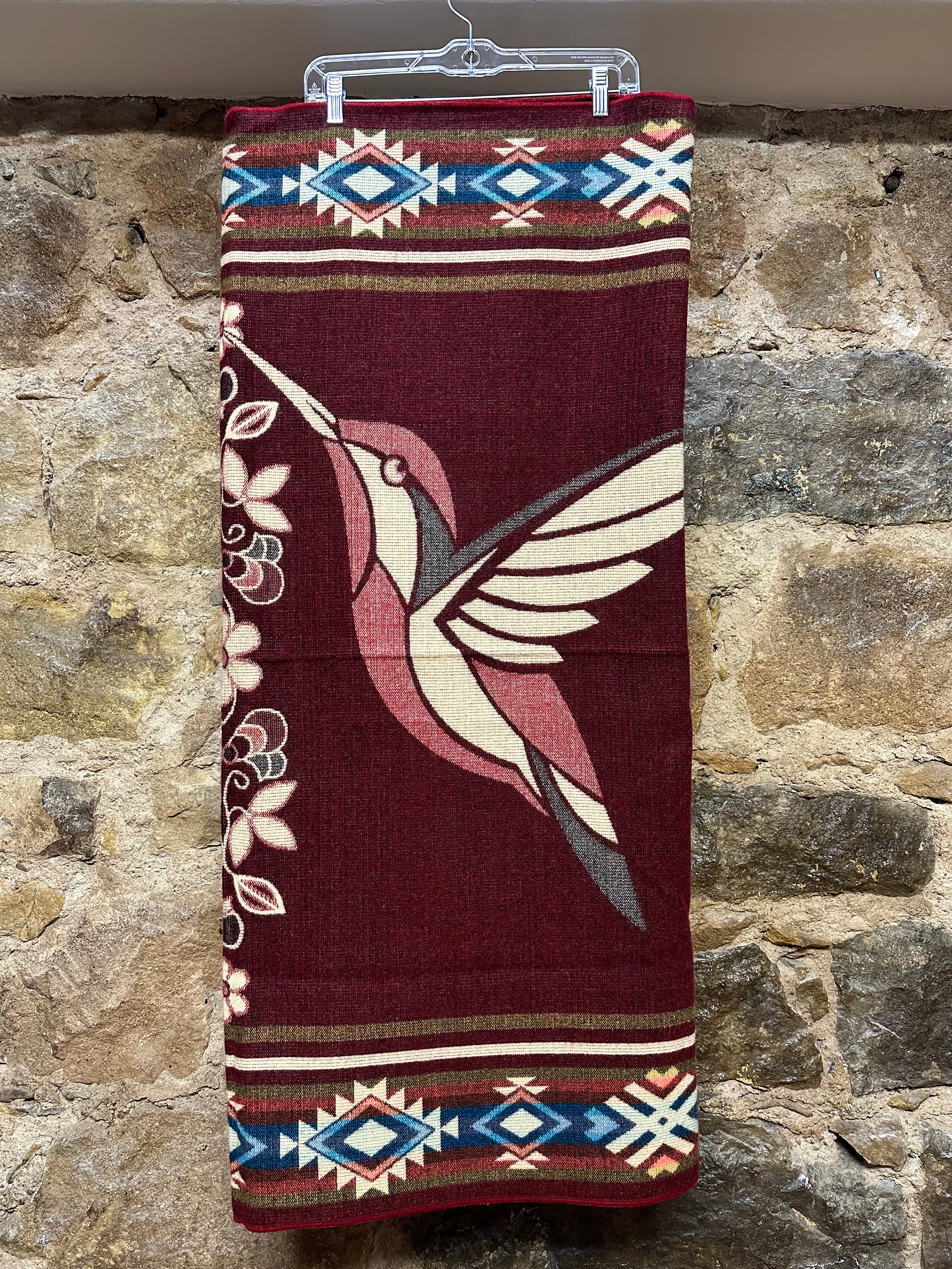 This cozy hummingbird blanket, made in Ecuador, is perfect for snuggling up this winter season! It's soft with a blend of 70% wool and 30% acrylic, keeping you warm and snug wherever you go. Whether you’re cuddling on the sofa, joining a campfire, or just taking an evening stroll, the hummingbird blanket will be the perfect companion and make the experience so much more enjoyable. With its unique design and delicate touch, this fun and festive blanket is sure to be the perfect addition to your home.