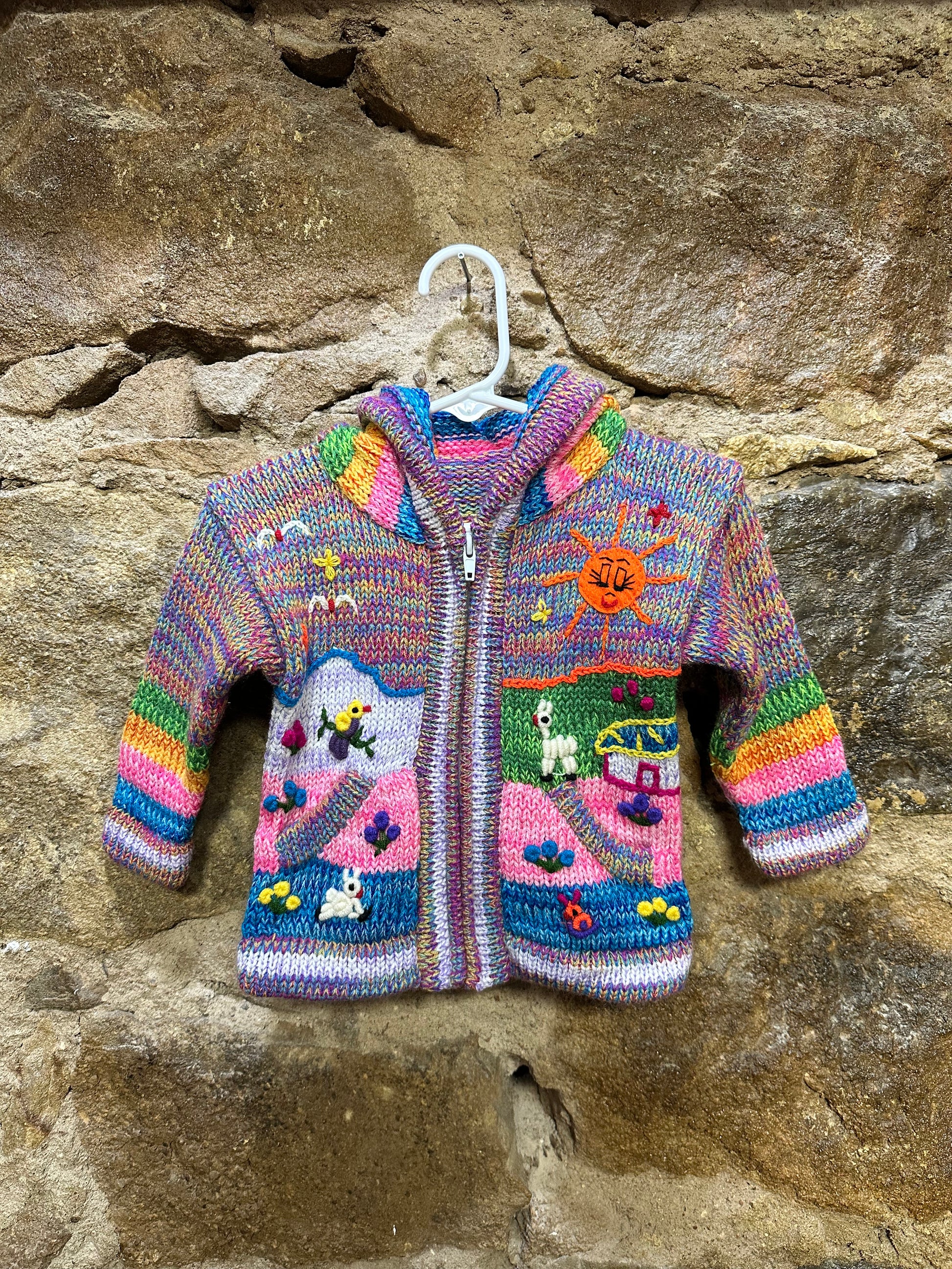 Children's Play Day Sweater! This beautiful, hand-stitched sweater is made with love in Peru and features friendly animals to make any playday special. It will keep your little one warm and cozy while they are out playing and exploring. With vibrant colors and cozy comfort, the Children's Play Day Sweater is perfect for all of your adventures!