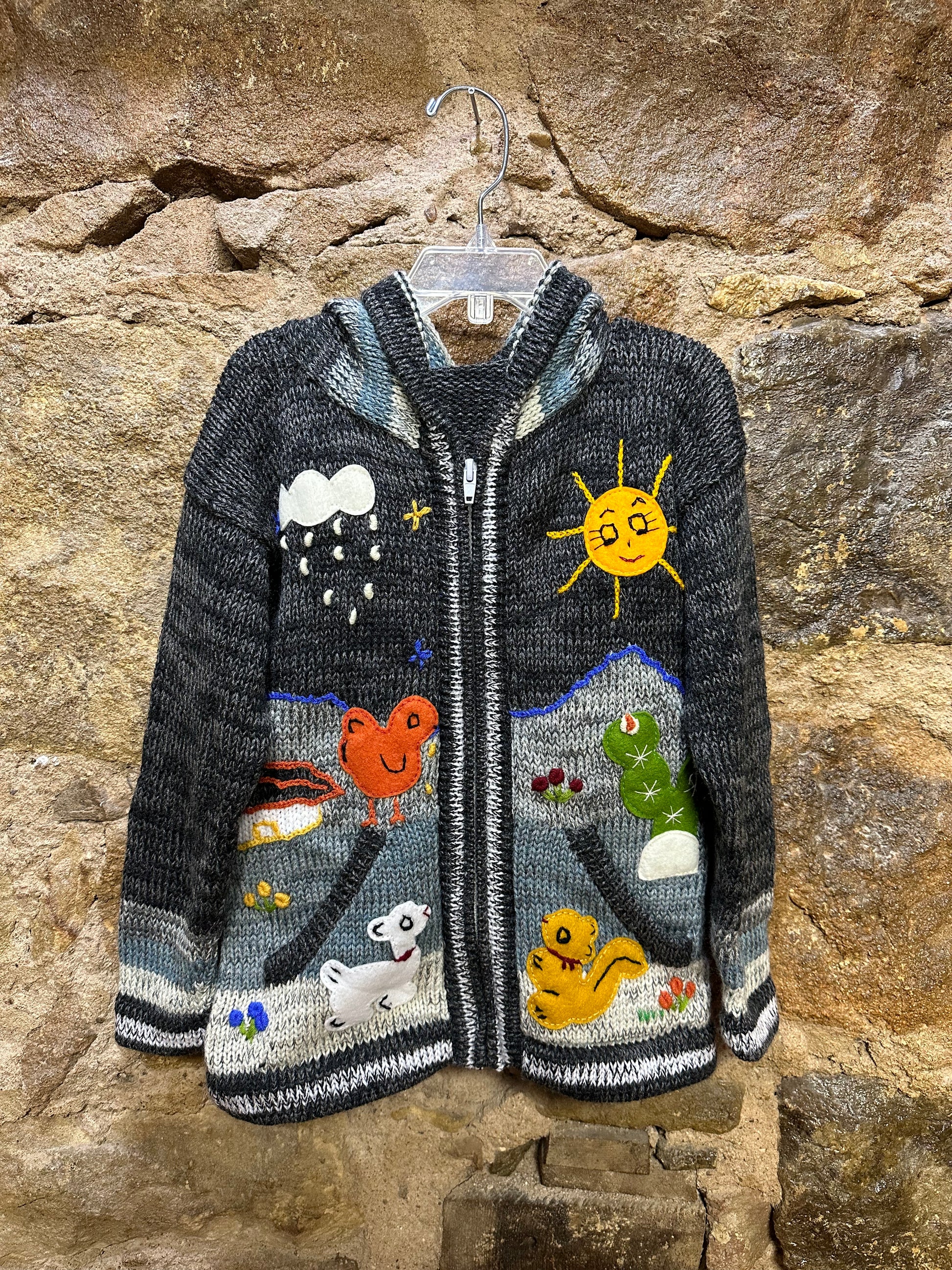 Children's Play Day Sweater! This beautiful, hand-stitched sweater is made with love in Peru and features friendly animals to make any playday special. It will keep your little one warm and cozy while they are out playing and exploring. With vibrant colors and cozy comfort, the Children's Play Day Sweater is perfect for all of your adventures!