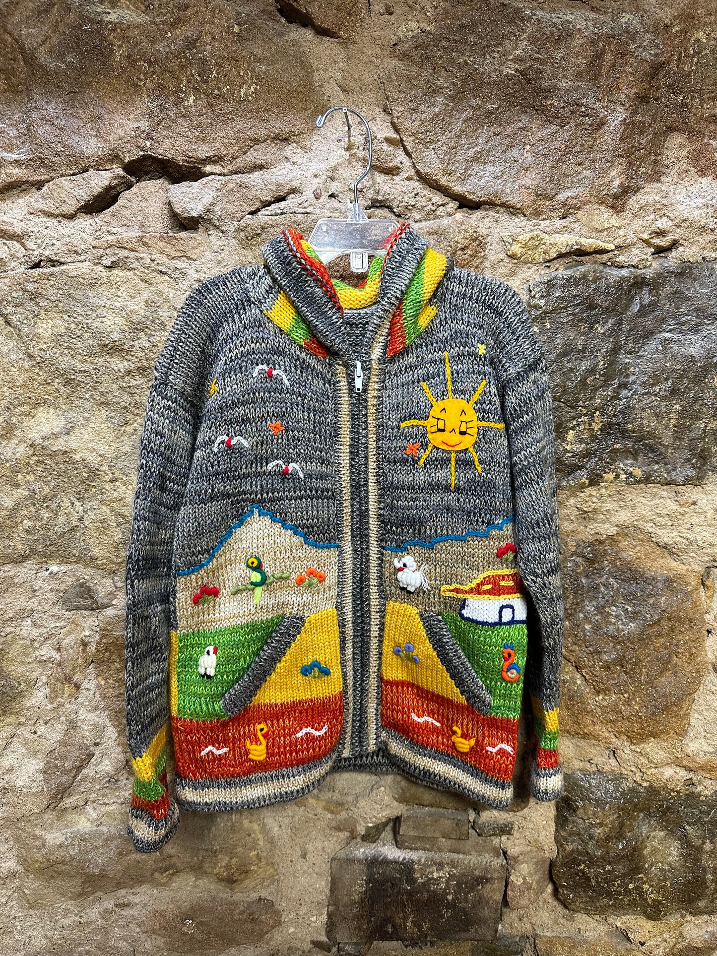 Children's Play Day Sweater! This beautiful, hand-stitched sweater is made with love in Peru and features friendly animals to make any playday special. It will keep your little one warm and cozy while they are out playing and exploring. With vibrant colors and cozy comfort, the Children's Play Day Sweater is perfect for all of your adventures!