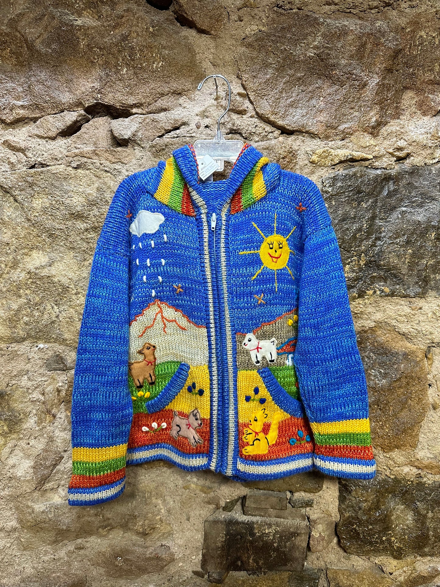 Children's Play Day Sweater! This beautiful, hand-stitched sweater is made with love in Peru and features friendly animals to make any playday special. It will keep your little one warm and cozy while they are out playing and exploring. With vibrant colors and cozy comfort, the Children's Play Day Sweater is perfect for all of your adventures!