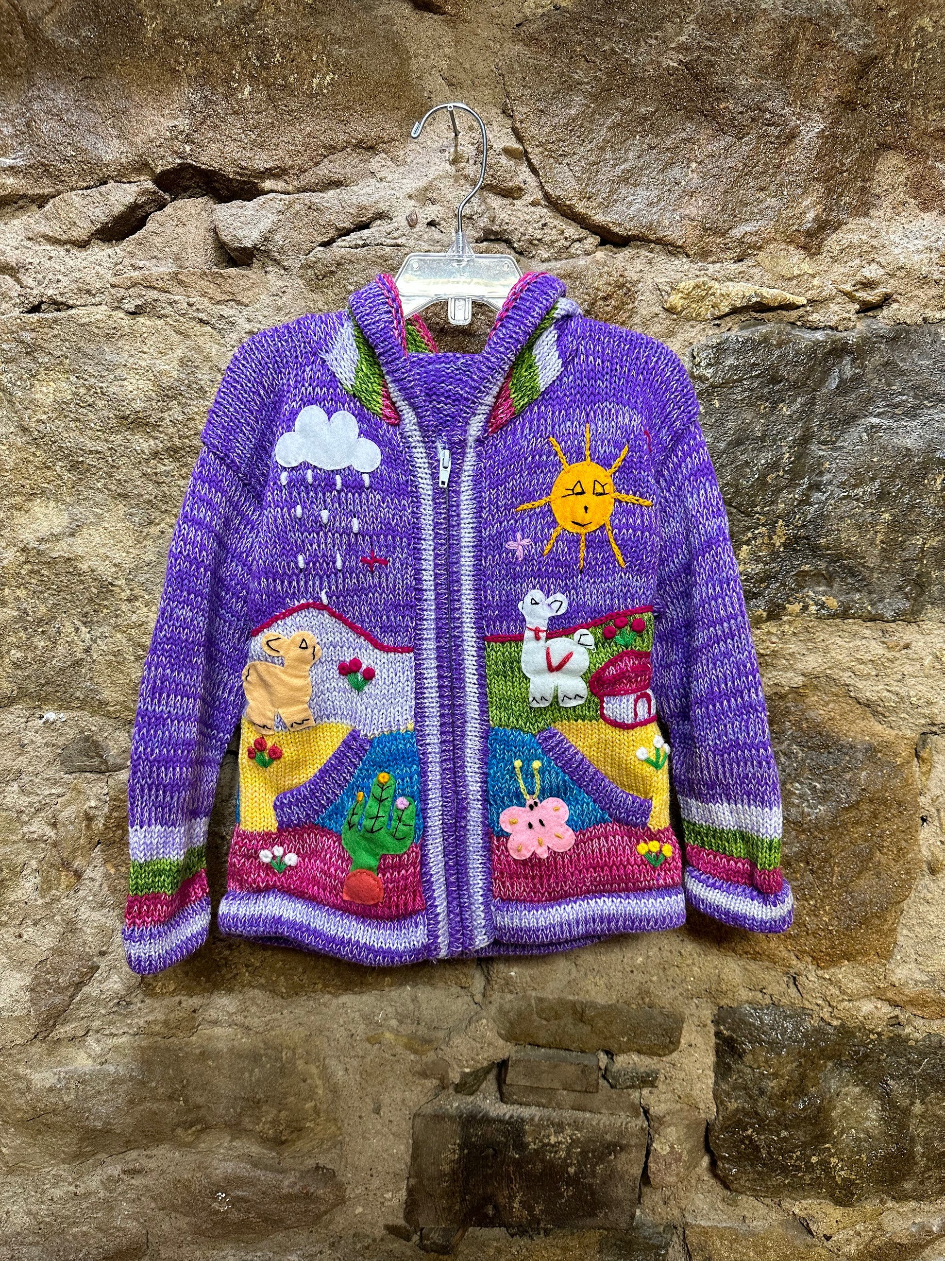 Children's Play Day Sweater! This beautiful, hand-stitched sweater is made with love in Peru and features friendly animals to make any playday special. It will keep your little one warm and cozy while they are out playing and exploring. With vibrant colors and cozy comfort, the Children's Play Day Sweater is perfect for all of your adventures!