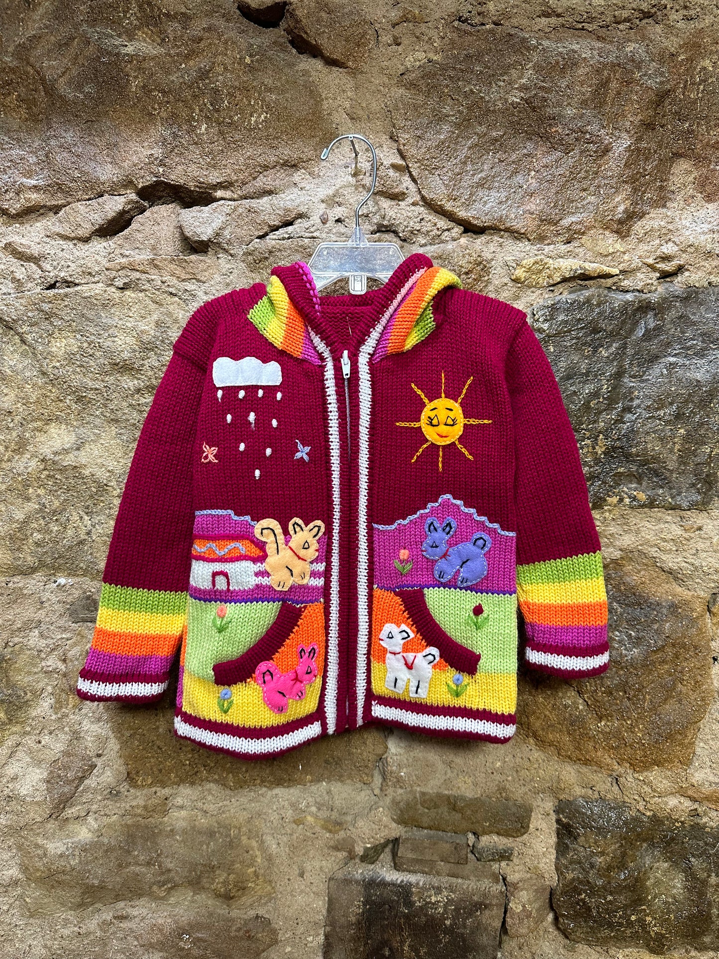 Children's Play Day Sweater! This beautiful, hand-stitched sweater is made with love in Peru and features friendly animals to make any playday special. It will keep your little one warm and cozy while they are out playing and exploring. With vibrant colors and cozy comfort, the Children's Play Day Sweater is perfect for all of your adventures!