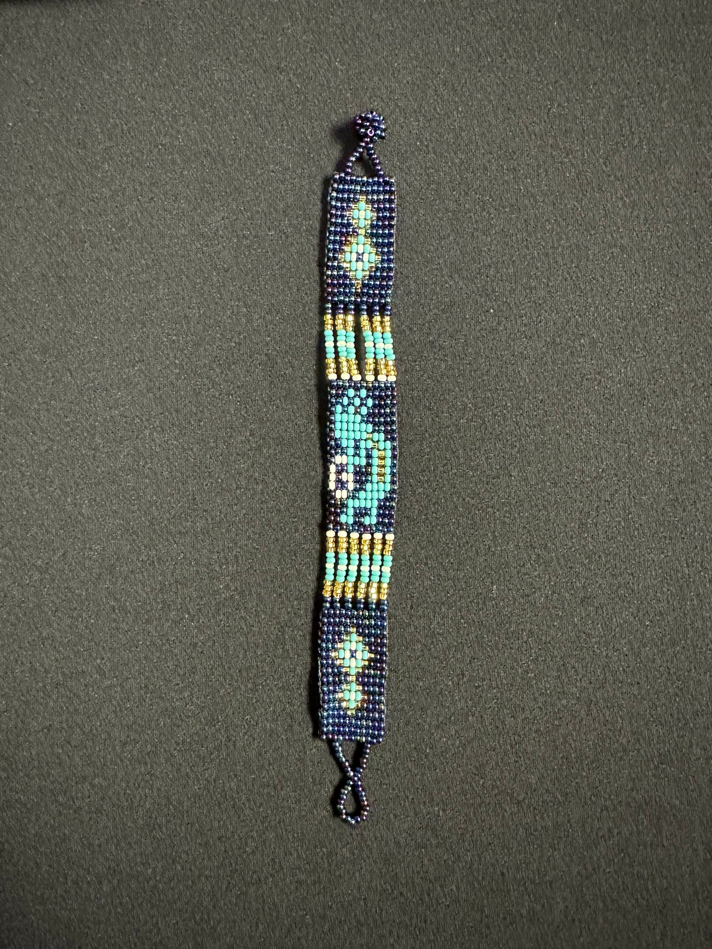 This beautiful hand-made Guatemalan accessory is a great addition to any jewelry collection! The bracelet boasts fun, vibrant colors inspired by the vibrant palette of the native culture. It's sure to turn heads with its unique design and beautiful hues. Add a bit of fun and excitement to your look with the Kokopelli Design Bracelet!