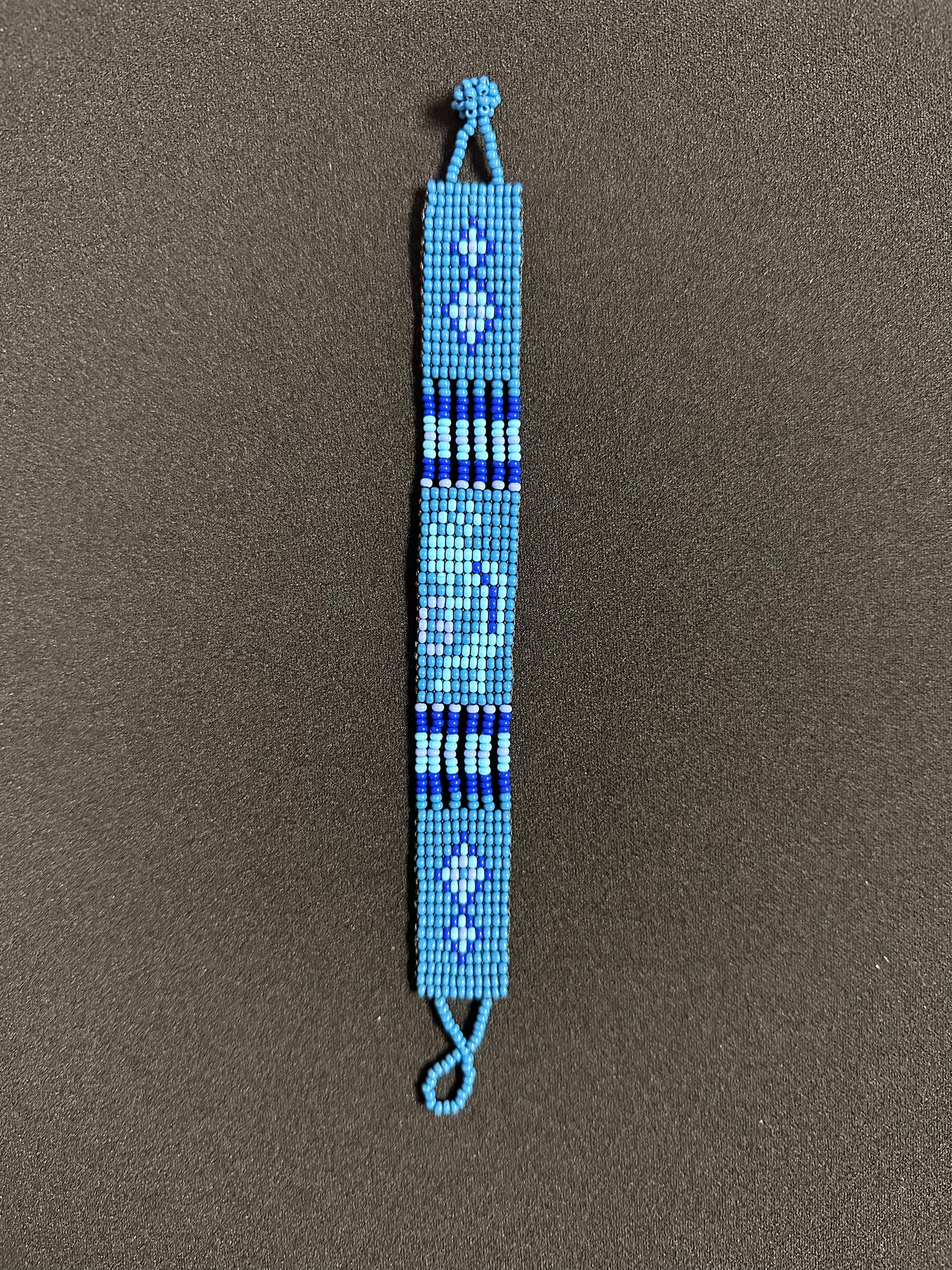 This beautiful hand-made Guatemalan accessory is a great addition to any jewelry collection! The bracelet boasts fun, vibrant colors inspired by the vibrant palette of the native culture. It's sure to turn heads with its unique design and beautiful hues. Add a bit of fun and excitement to your look with the Kokopelli Design Bracelet!