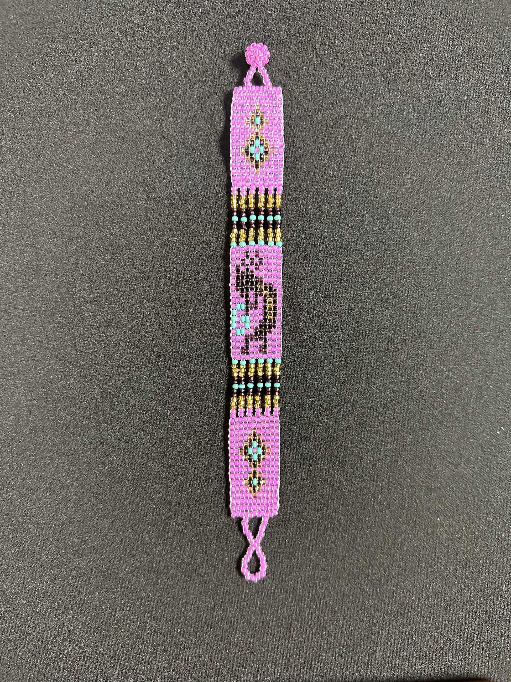 This beautiful hand-made Guatemalan accessory is a great addition to any jewelry collection! The bracelet boasts fun, vibrant colors inspired by the vibrant palette of the native culture. It's sure to turn heads with its unique design and beautiful hues. Add a bit of fun and excitement to your look with the Kokopelli Design Bracelet!